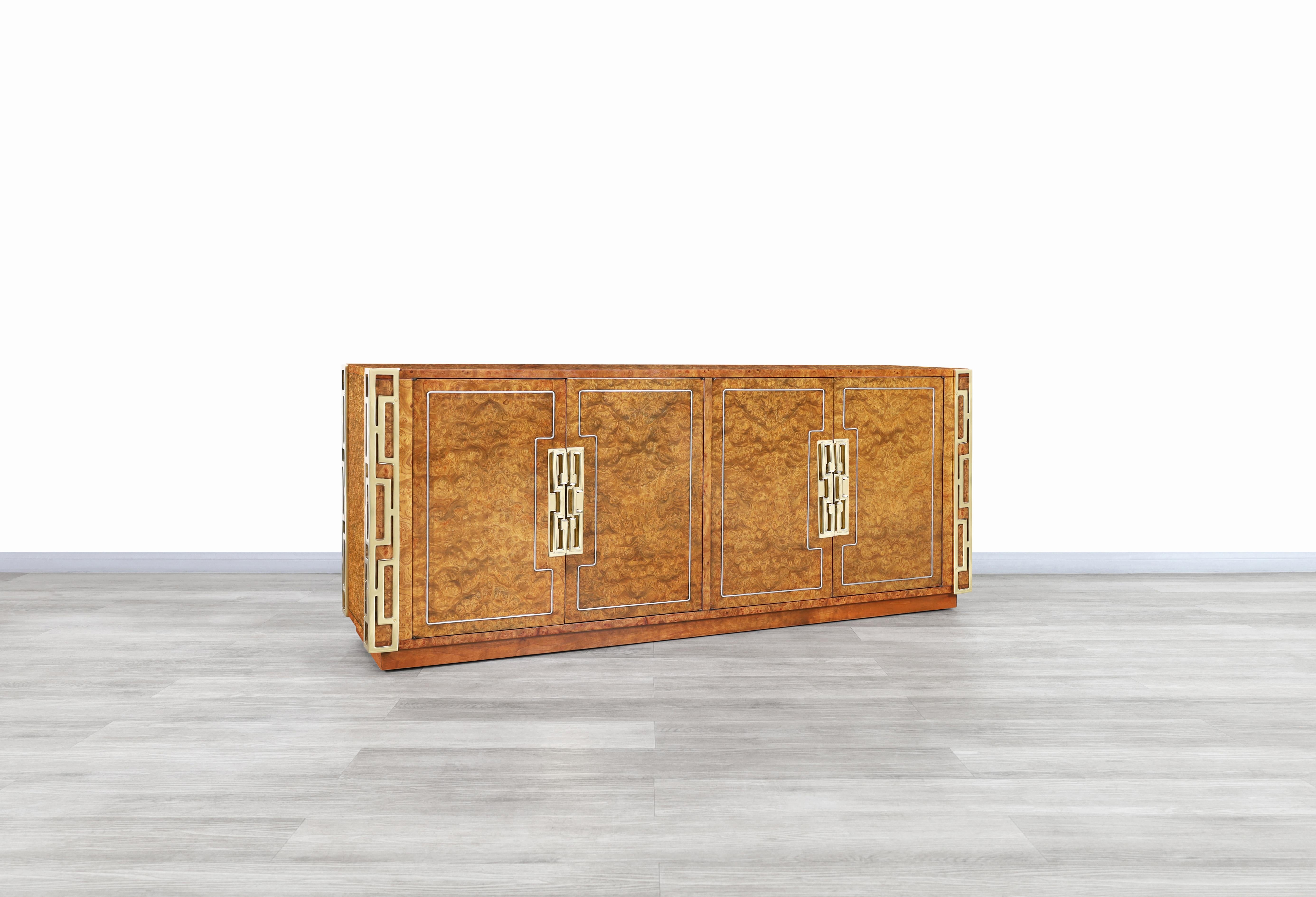 Beautiful vintage burl wood and brass credenza designed and manufactured by Mastercraft in the United States, circa 1970s. This credenza has been built from the highest quality burl wood and has a captivating design that will attract the eyes of any