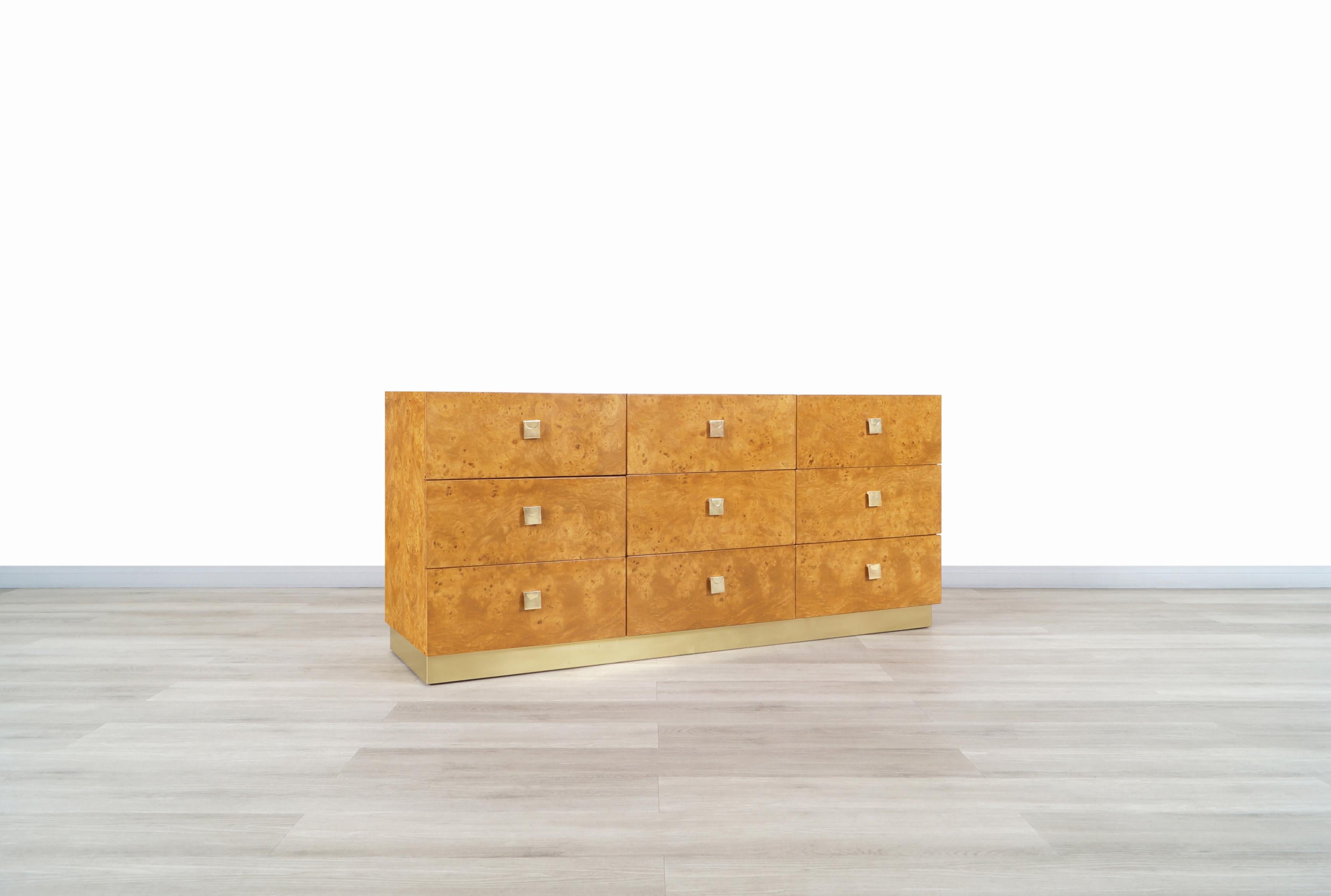 Wonderful vintage burl wood and brass dresser manufactured by Founders in the United States, circa 1980s. This dresser is inspired by the iconic designs of the famous designer Milo Baughman. This collection was characterized by having fine furniture