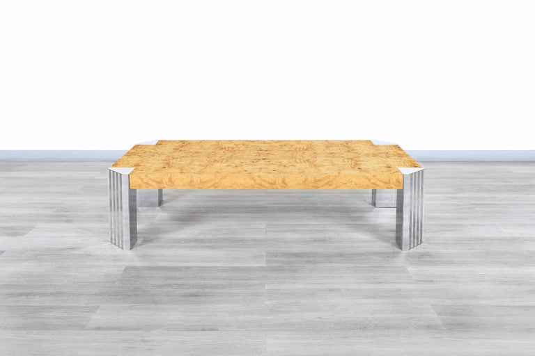 Stunning vintage burl wood and chrome “Skyscraper” coffee table inspired in the style of Milo Baughman and manufactured in the United States, circa 1970s. This table has a minimalist design that stands out for the fine materials used in its