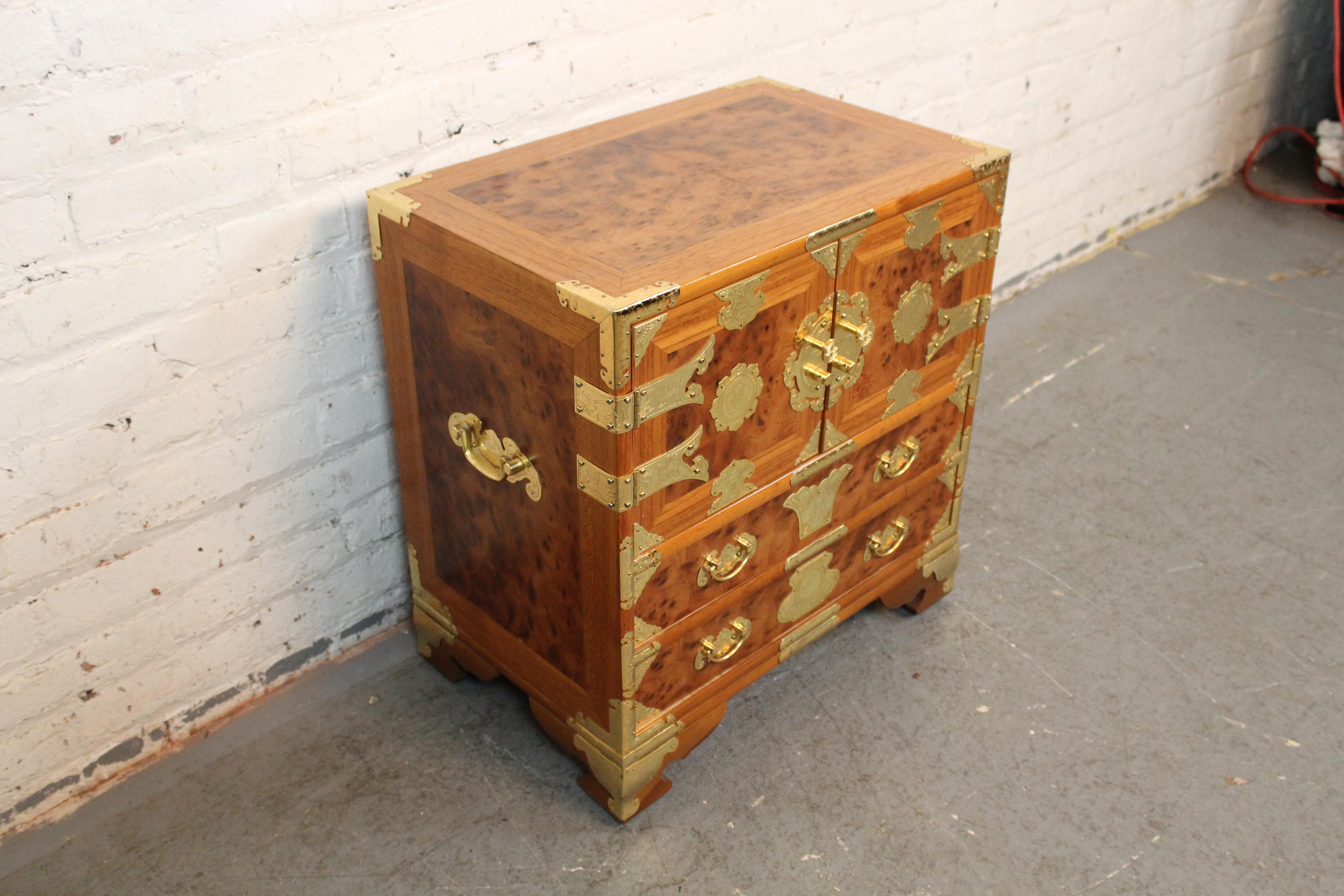 Bring home a sense of timeless adventure with this fantastic Asiatic burl wood tansu style chest. Upper double doors open to reveal a tidy cubby with two felt-lined, dovetailed drawers, while an additional pair of larger drawers sit underneath to
