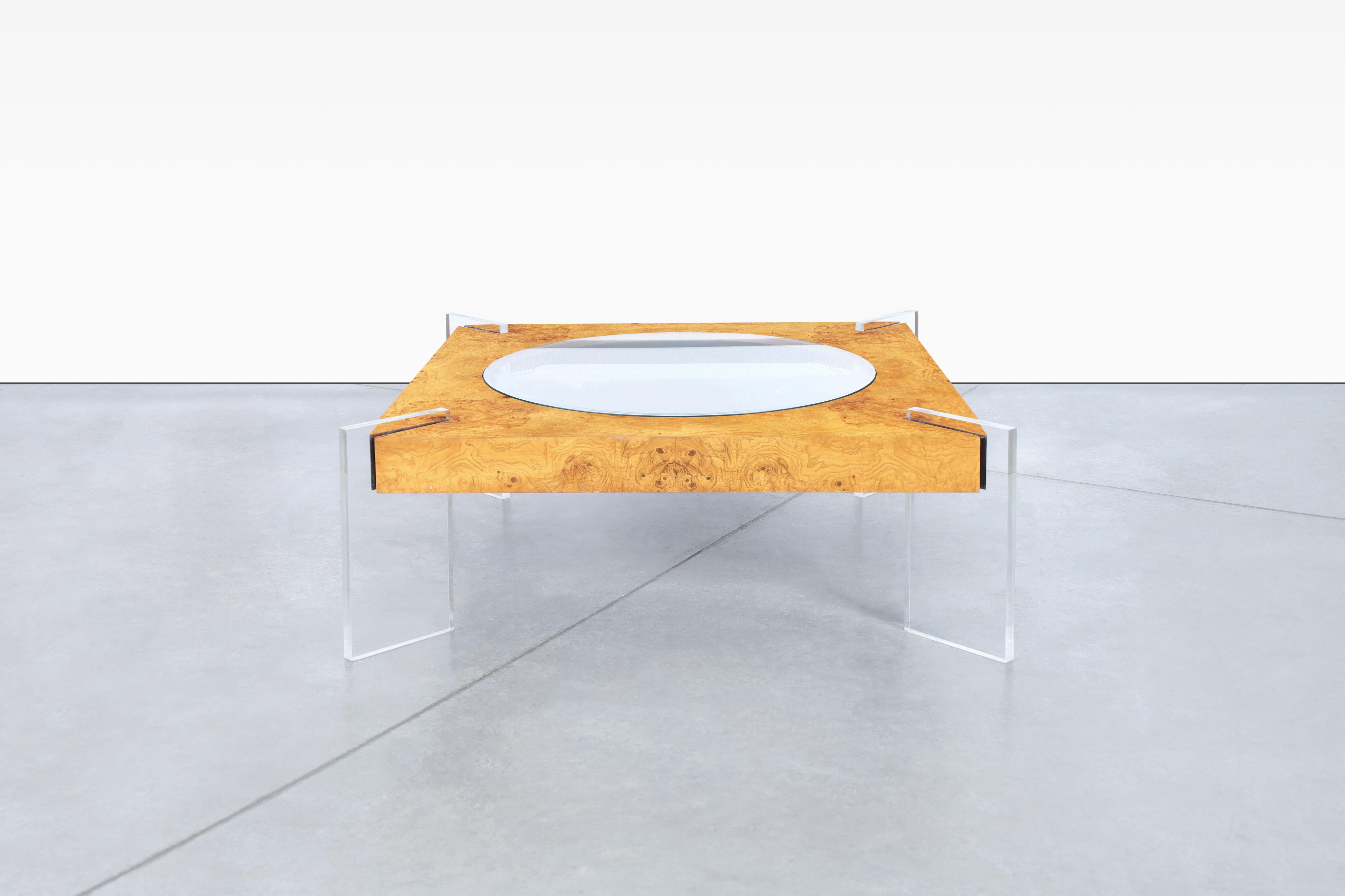 This stunning vintage coffee table by Vladimir Kagan, made in the United States during the 1970s, is a true masterpiece of design. Crafted from burl wood, the frame boasts a beautiful and unique grain pattern that is sure to catch the eye. The
