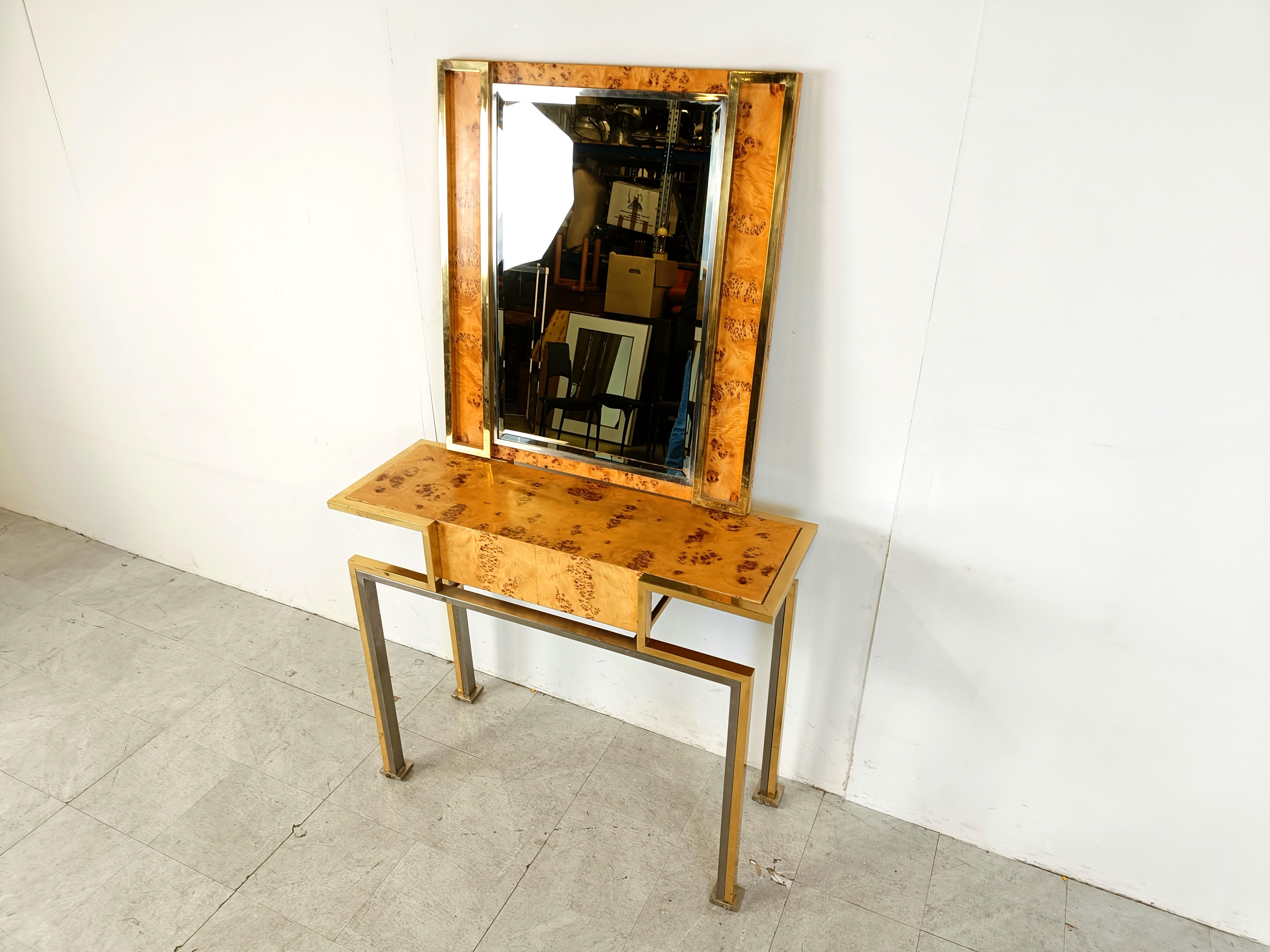 Hollywood regency console attributed to Willy Rizzo made from burl wood, brass and chrome.

It also comes with its matching mirror, which is rare.

The piece might very well be from Willy Rizzo, but unless catalogued or signed, we will not guarantee