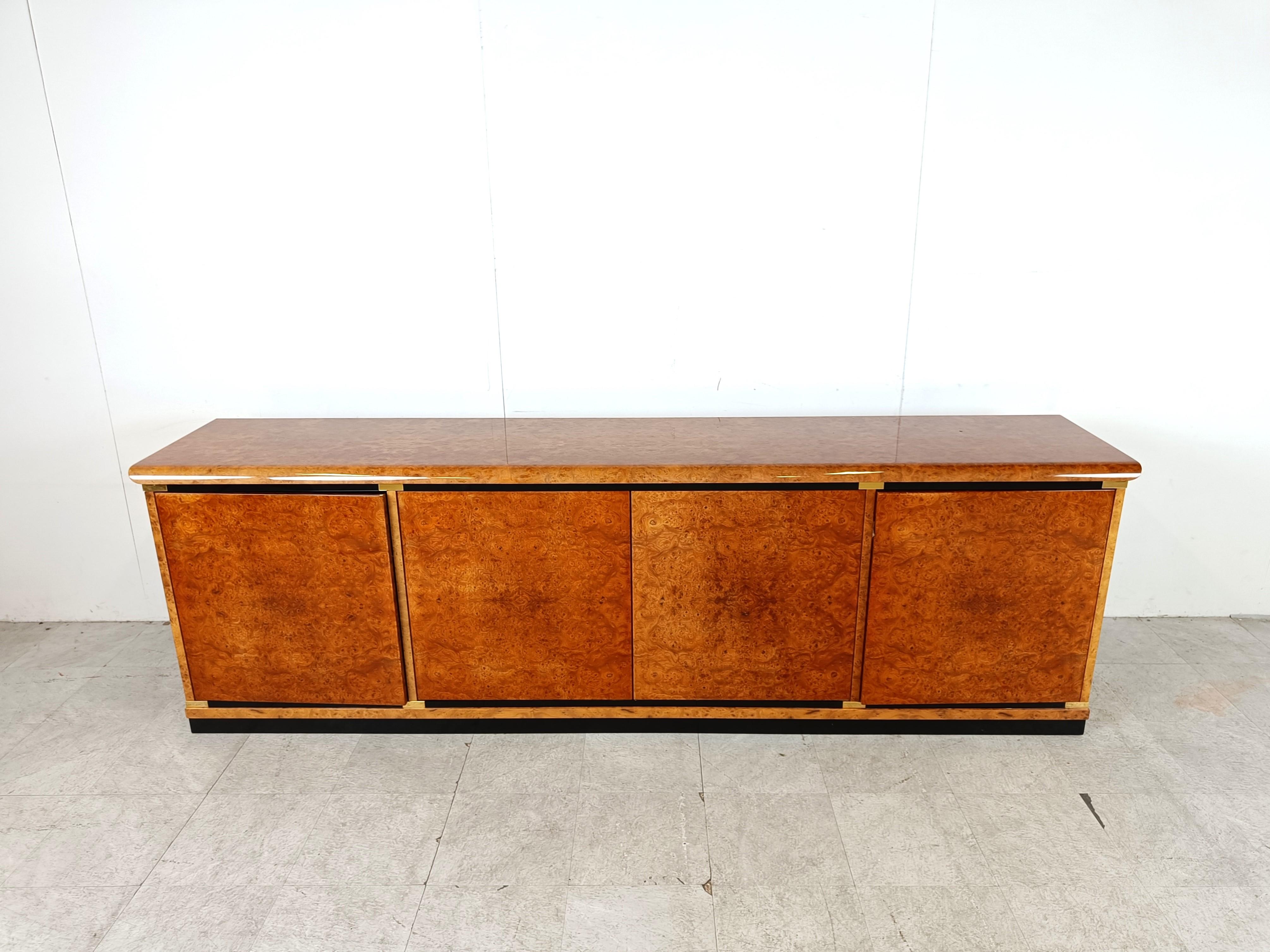 High quality burl wood sideboard/credenza.

This piece has been built with extremely high quality and is finished in burl wood all over. (outside, inside and even beautifully finished at the back)

It consists of 4 doors with 4 integrated drawers