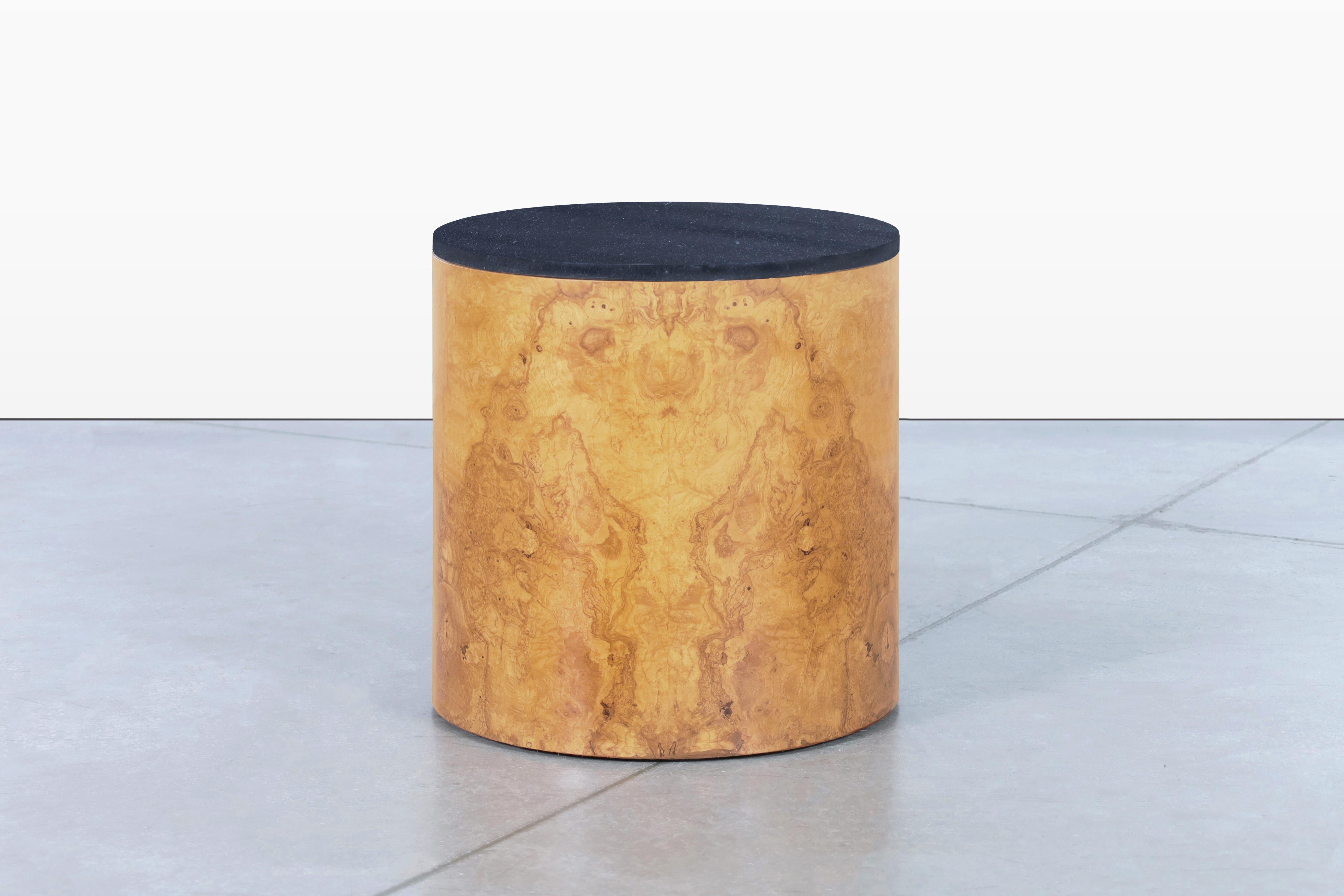 Beautiful vintage burl wood “drum” side table designed by Paul Mayen for Habitat International, circa 1970s. This beautifully restored side table offers an exquisite combination of stunning olive burl wood and a luxurious granite top, exuding an