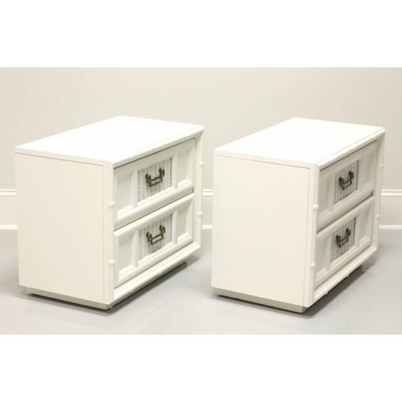 A pair of Asian style nightstands by Burlington House. Pecan, wicker panels and faux bamboo styling all freshly painted an ivory color. Features two drawers of dovetail construction with brass hardware. Made in Lexington, North Carolina, USA, in the