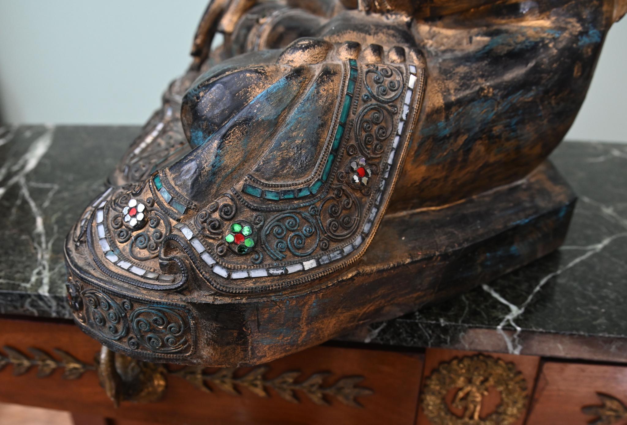 You are viewing a wonderful Burmese buddha statue 
Buddha is seated in meditation pose with cross legs and hand outstretched
Black finish with encrusted coloured stones in the dress
This would add an air of calm and serenity to any interior
Offered
