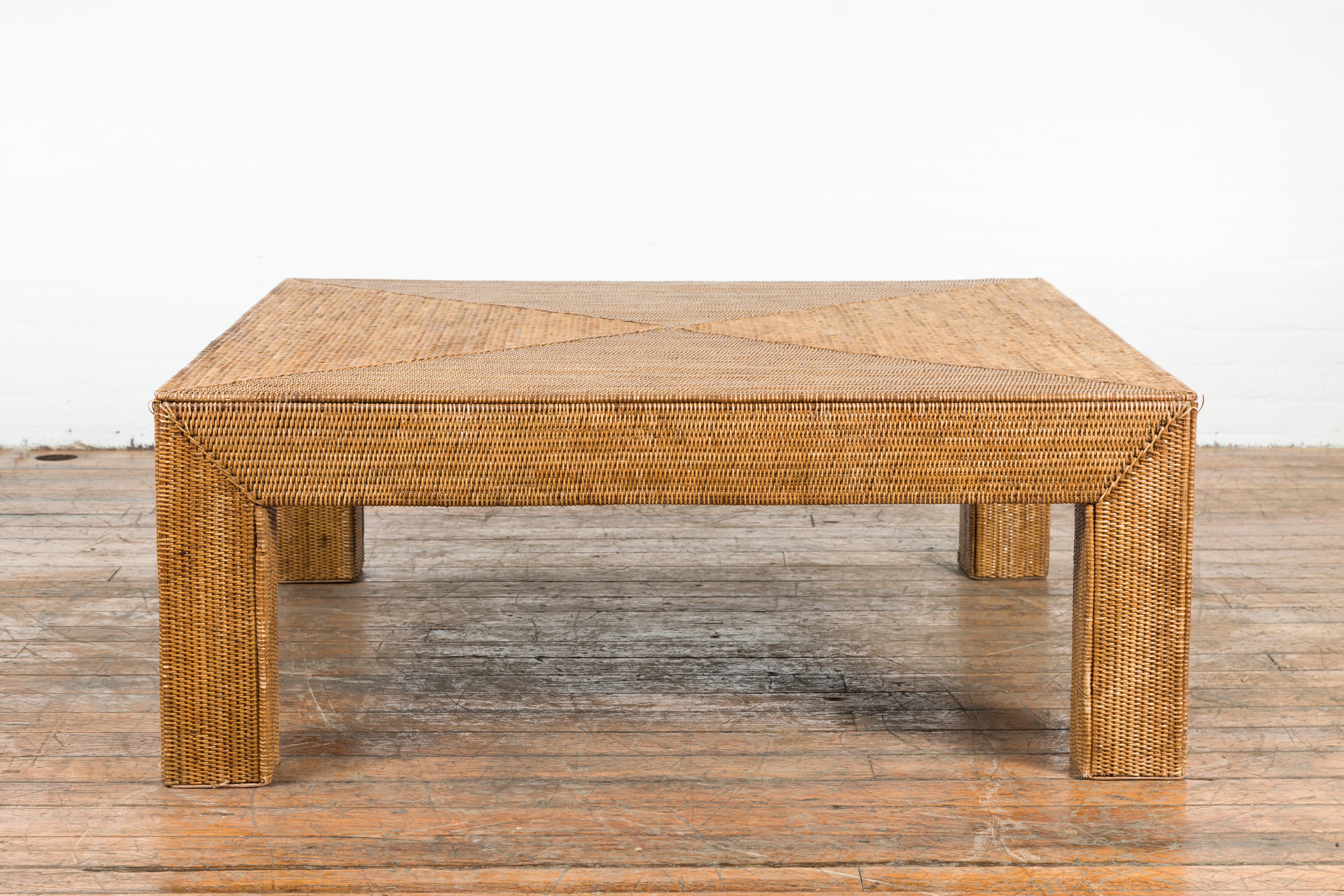 A Burmese vintage rattan parsons leg coffee table from the mid 20th century, hand-stitched over wood. We currently have several available, priced and sold $3,250 each. Created in Burma during the midcentury period, this Parsons leg coffee table