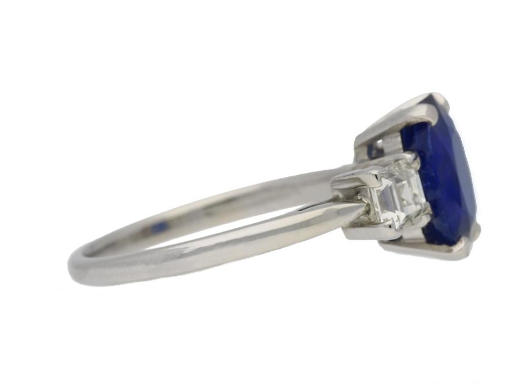 Vintage Burmese sapphire and diamond engagement ring. Set to centre with one cushion shape old cut natural unenhanced Burmese sapphire in an open back four claw setting with an approximate weight of 3.00 carats, flanked by two square step cut