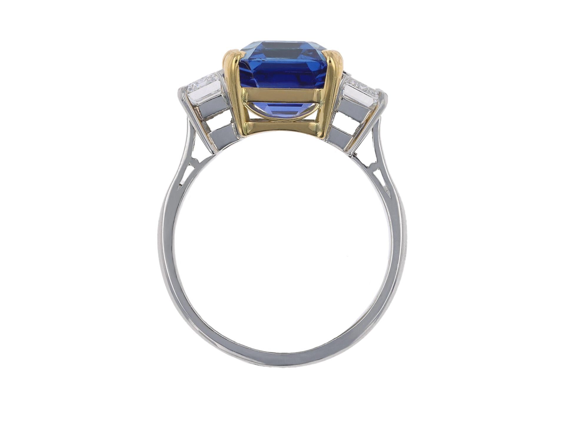 Vintage Burmese sapphire and diamond ring. Centrally set with an octagonal emerald-cut natural unenhanced Burmese sapphire in an open back claw setting with an approximate weight of 5.94 carats, flanked by one octagonal emerald-cut diamond, D