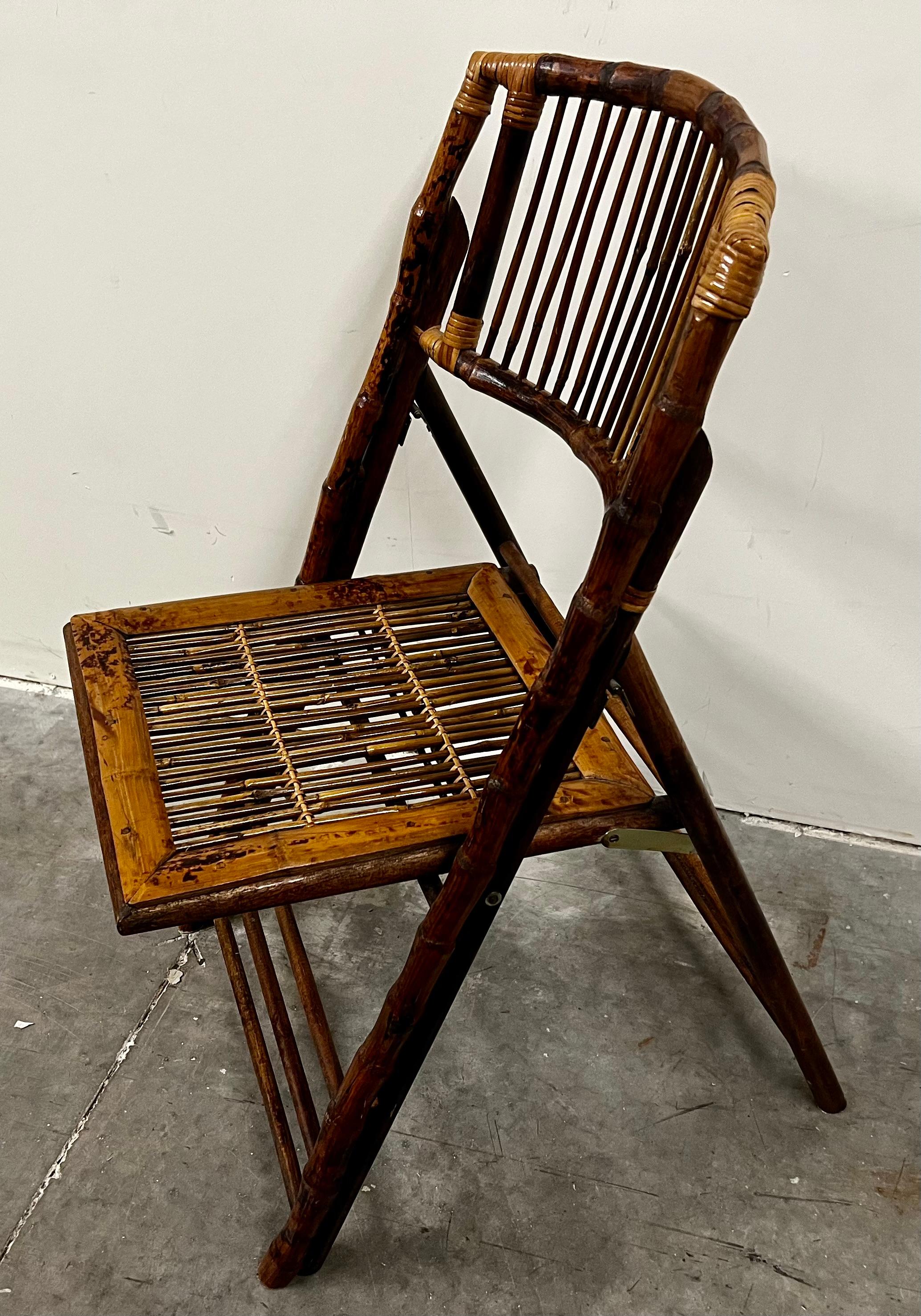 Vintage burnt bamboo and rattan collapsible side chair.  Very handsome and comfortable.
You might add a cushion for a pop of color.  Great for extra seating.  When not needed fold and store.
H-35.5”
W-18.5”
D-22”
Folded-3.5”
Seat Height-18