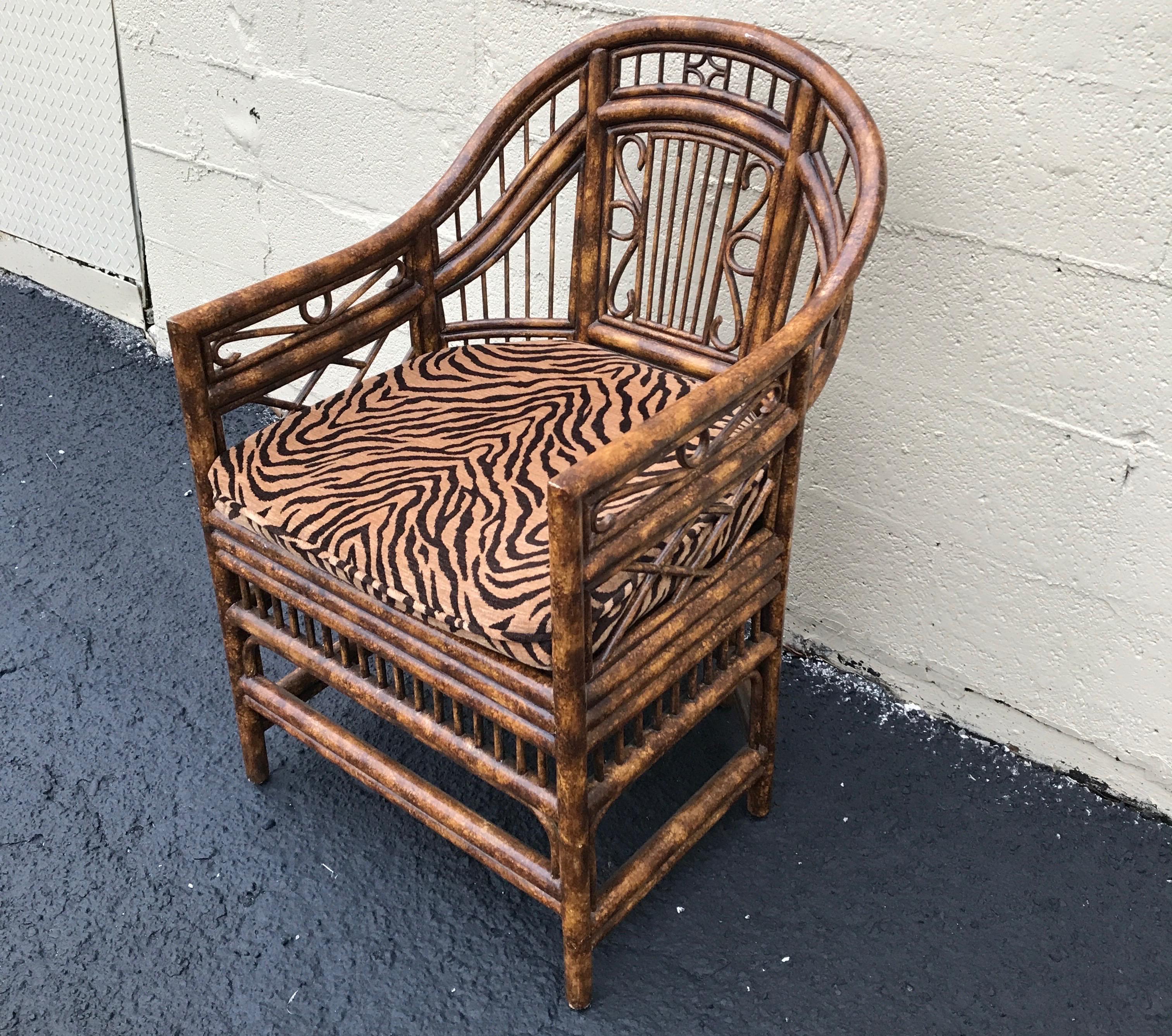 Single burnt bamboo Brighton chair with cane seat and tiger print cushion.