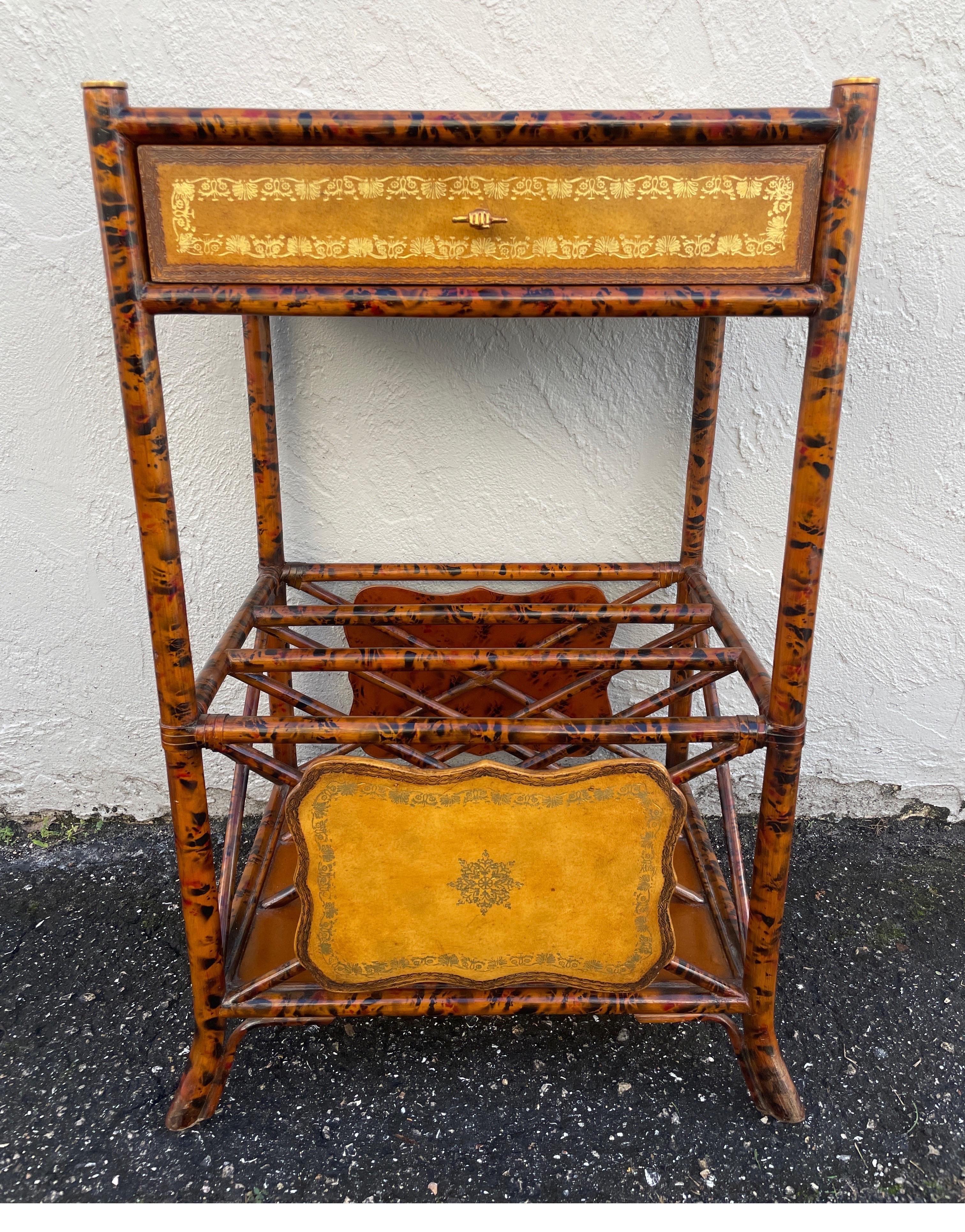 Striking two tiered burnt bamboo & embossed leather side table with one drawer. This table has a bottom shelf with compartments for storage.