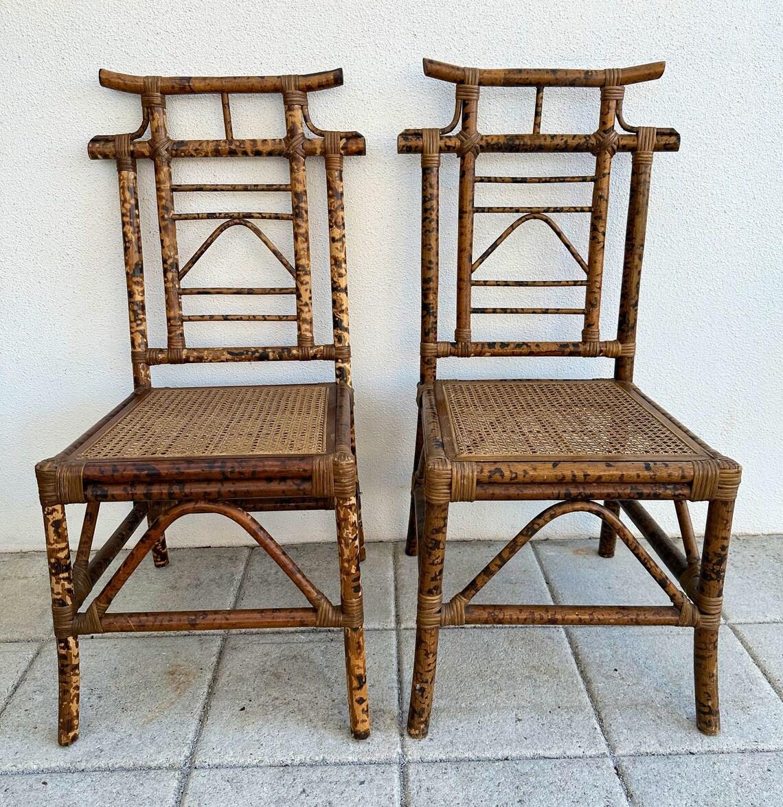 Rare set of 4 vintage burnt bamboo dining chairs. Pagoda design, beautifully rich in color, cane seats. Good vintage condition with some wear throughout. One of the cane seats was recently replaced. These chairs would be a great addition to any Palm