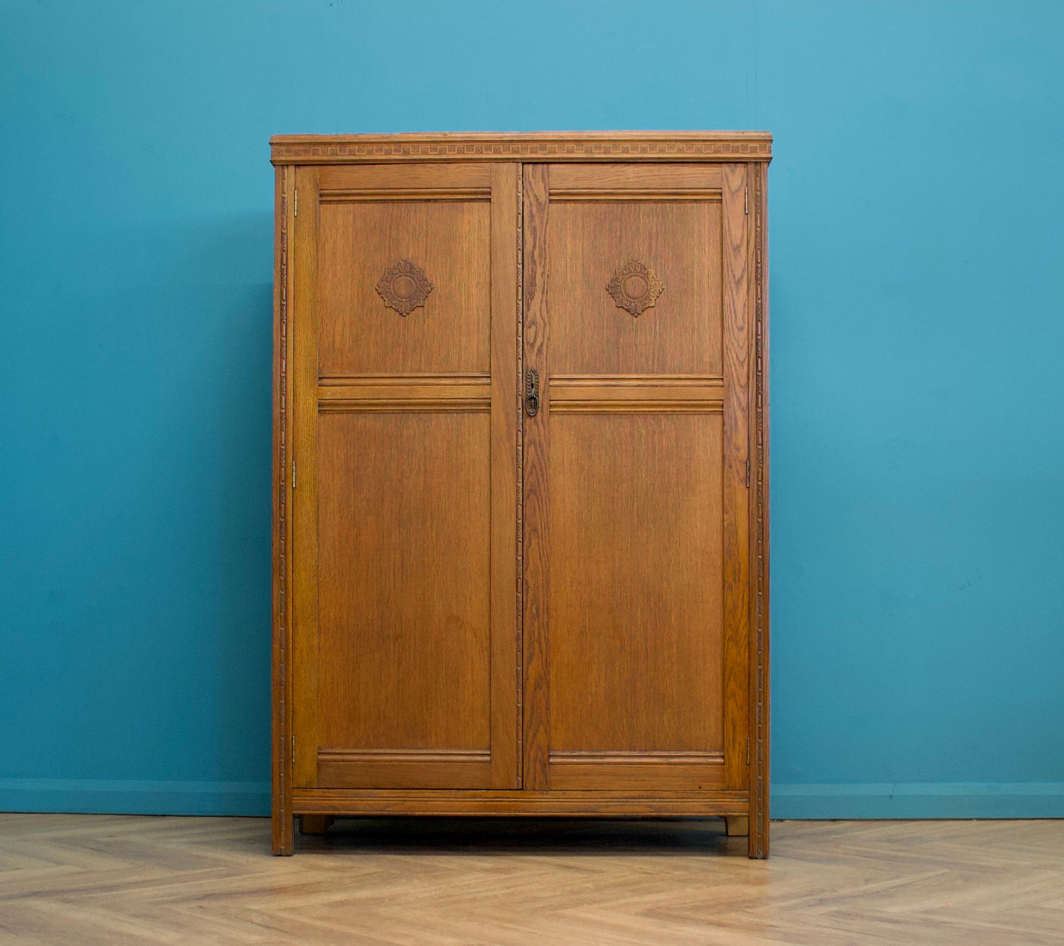 A vintage Oak Art Deco compactum / compact wardrobe
Made by Harris Lebus, circa 1930's (hinges stamped HL)
Inside is beautifully fitted out with a pull out clothes rail, metal shelves , two drawers, a shoe rack and two pull out trouser hangers