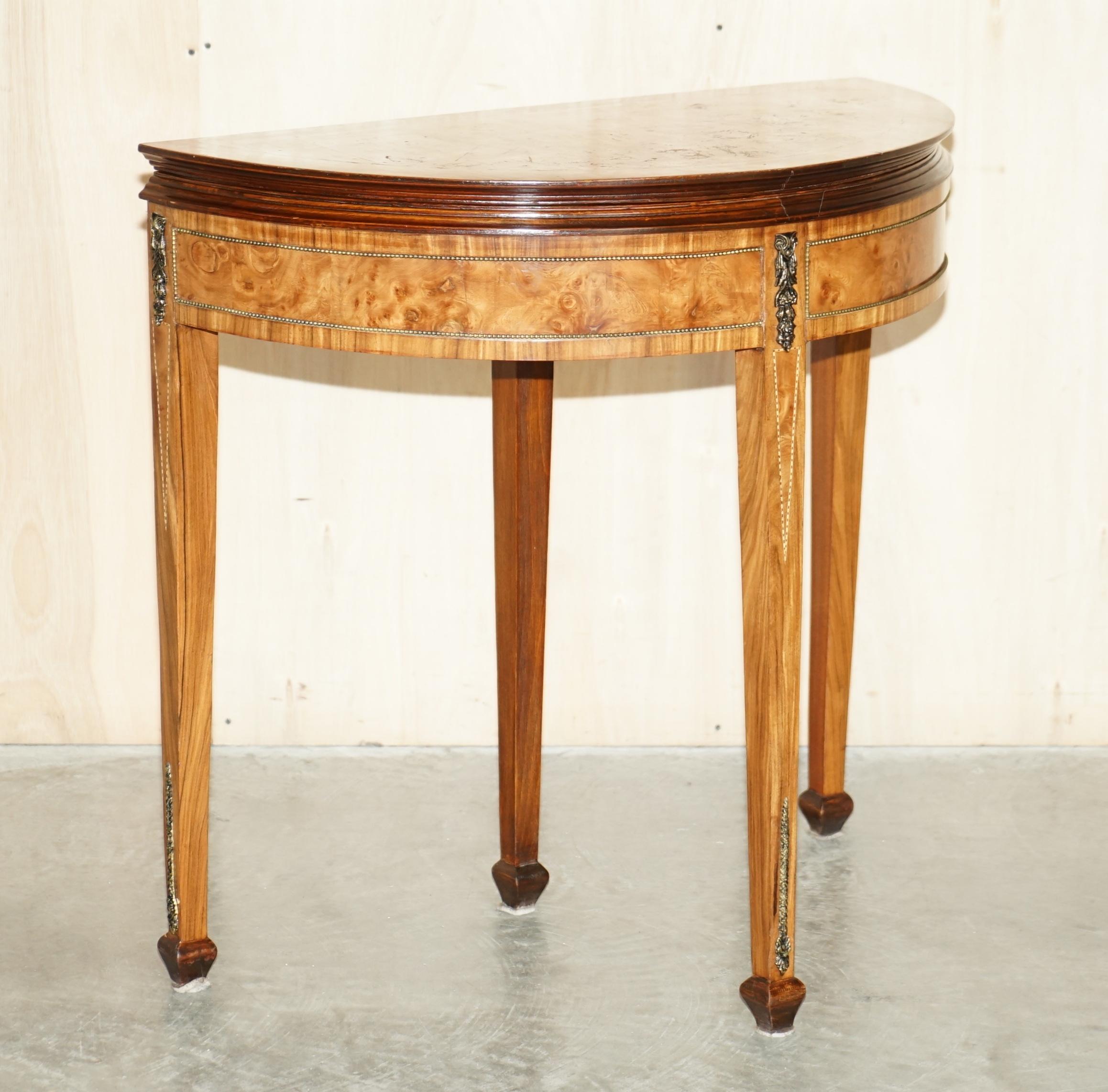We are delighted to offer for sale this lovely circa 1900-1920 burr walnut demi lune games card table with lovely burl finish.

A very good looking and well made piece, made in the Regency style however it is late Victorian to Edwardian. The piece