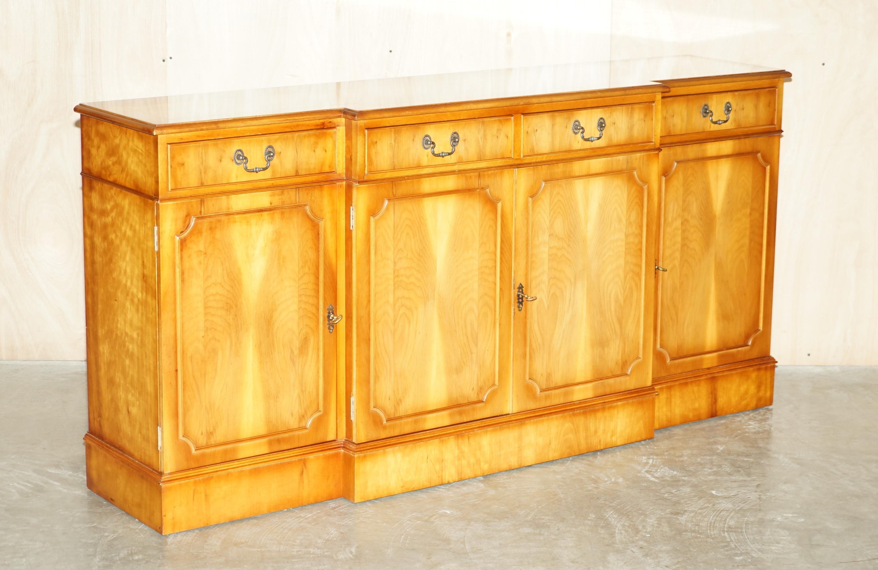 We are delighted to offer for sale this lovely burr yew wood four cupboard and drawer sideboard with original key

A very good looking and well made piece. This is very utilitarian with large sized sideboard with drawers, the breakfront really