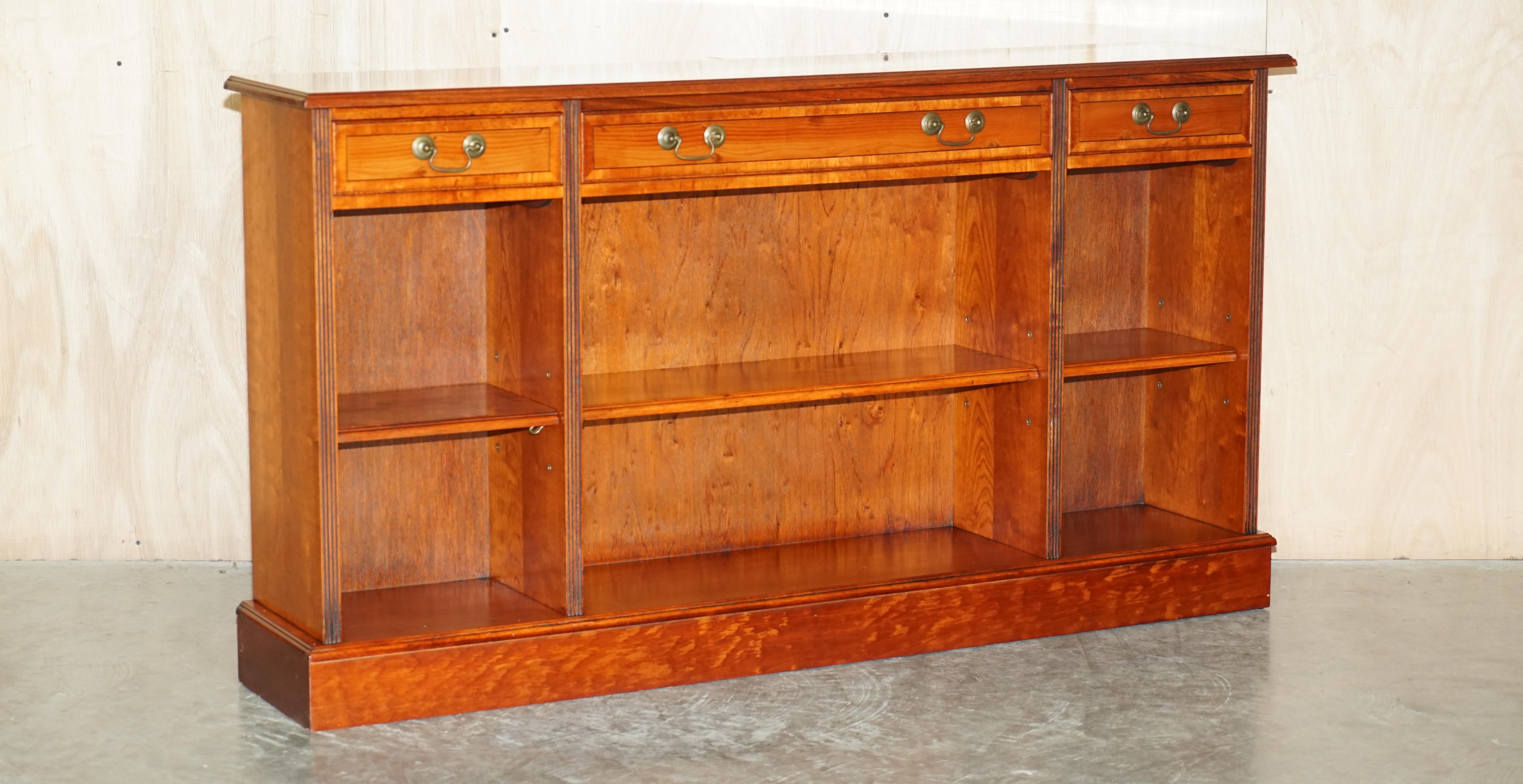 We are delighted to offer for sale this lovely vintage Burr Yew wood open library bookcase / sideboard with drawers 

A good looking and utilitarian piece of furniture, it looks good in any setting, the shelves are all height adjustable to fit