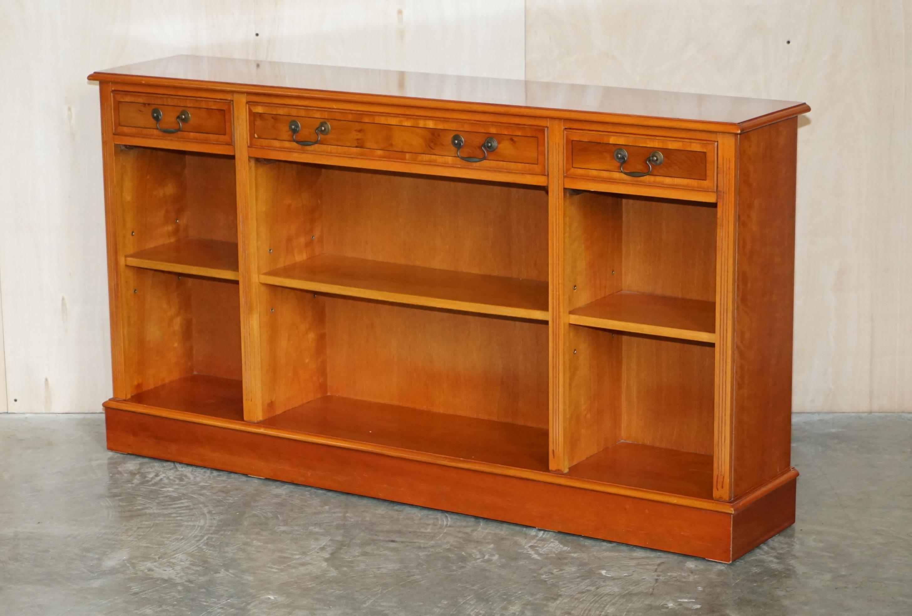 We are delighted to offer for sale this lovely vintage Burr Yew wood open library bookcase / sideboard with drawers. 

A good looking and utilitarian piece of furniture, it looks good in any setting, the shelves are all height adjustable to fit