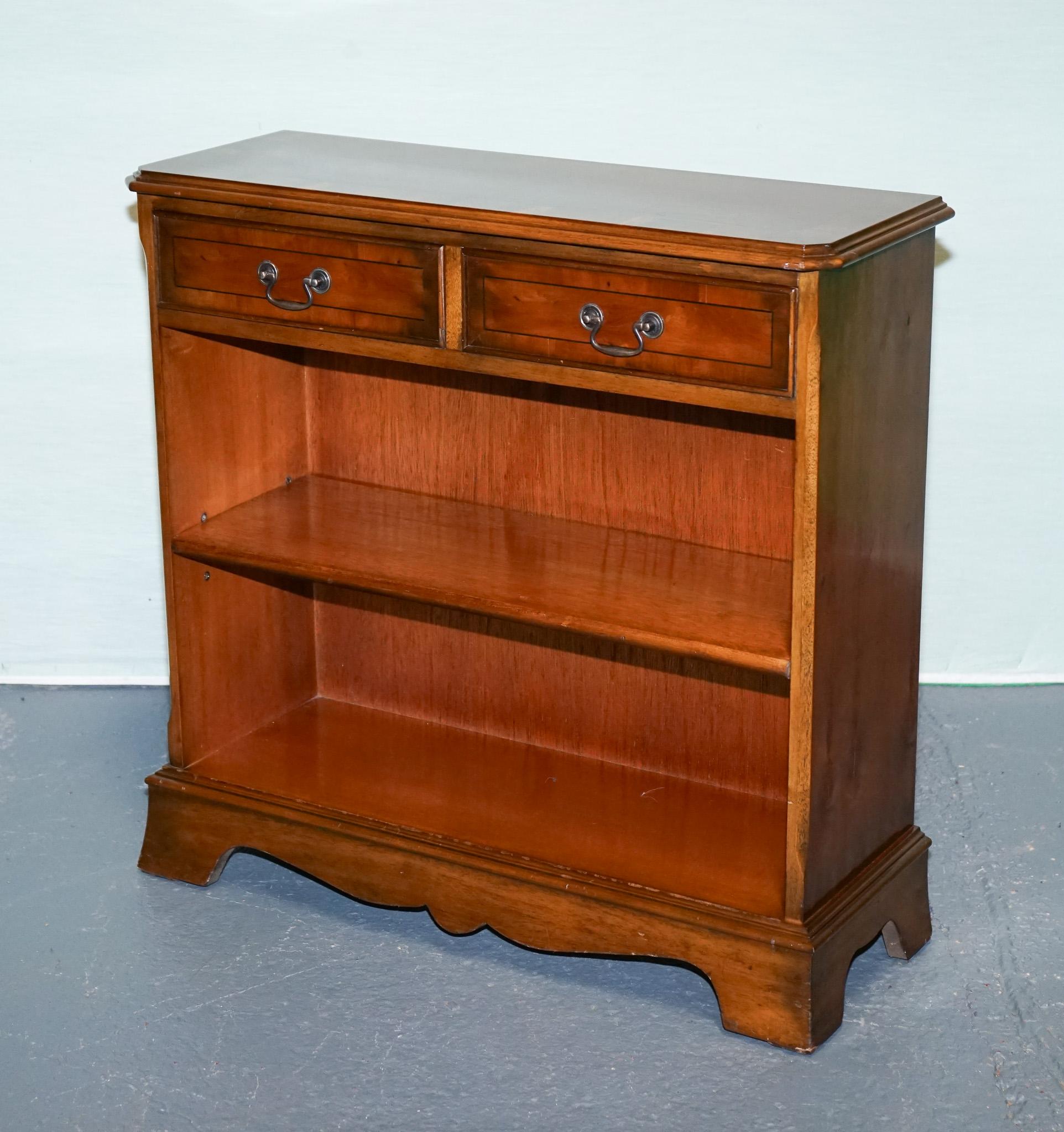 
Antiques of London



A distinguished vintage dwarf library bookcase crafted from richly grained burr yew wood. 

It features a rectangular top with delicate moulded edging, two finely lined drawers with elegant bail handles, and two open