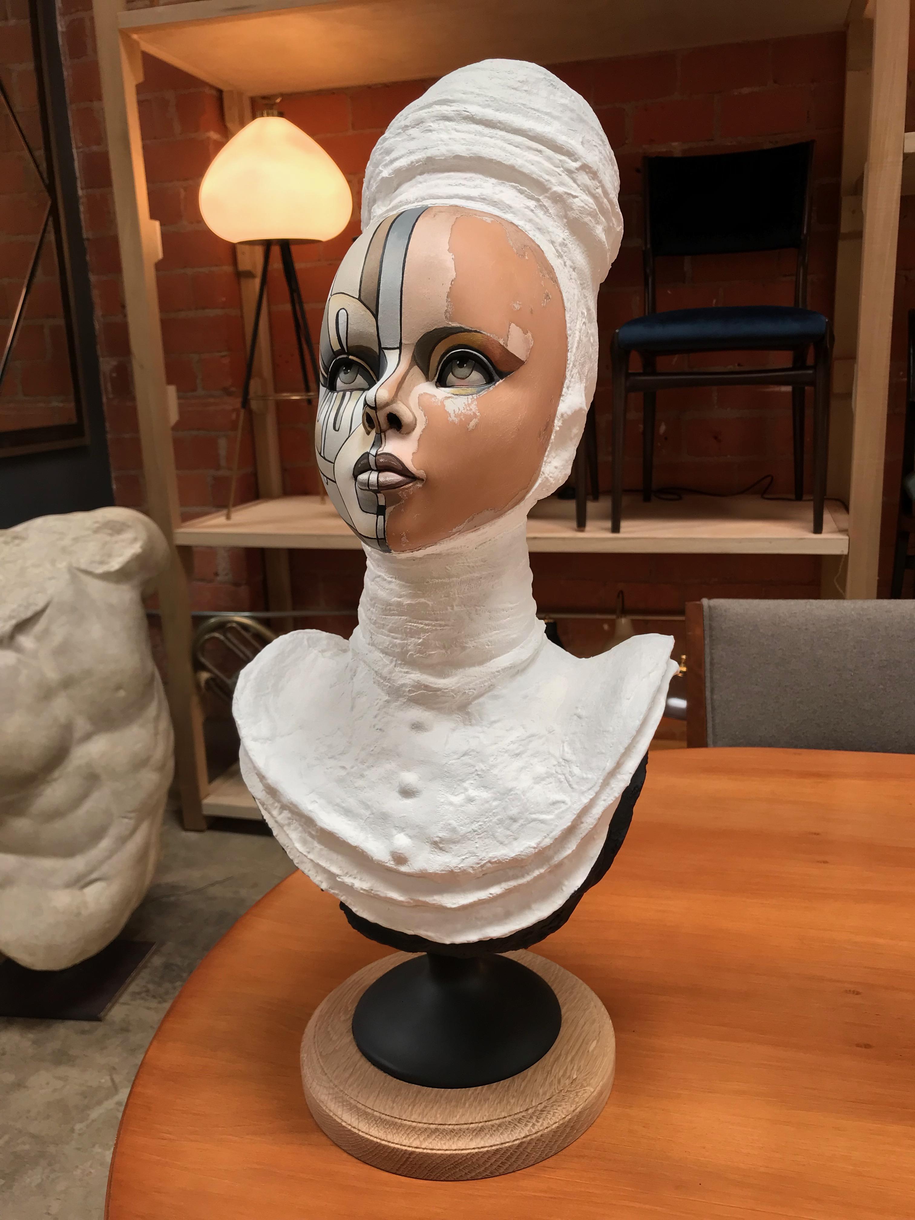 Bust of a young women, signed David Gilmore, USA, 2019.
Each bust started with a vintage mannequin head which was then placed on either a metal or glass stand. The artist, David Gilmore, painted a pattern over their faces in a similar manner to his