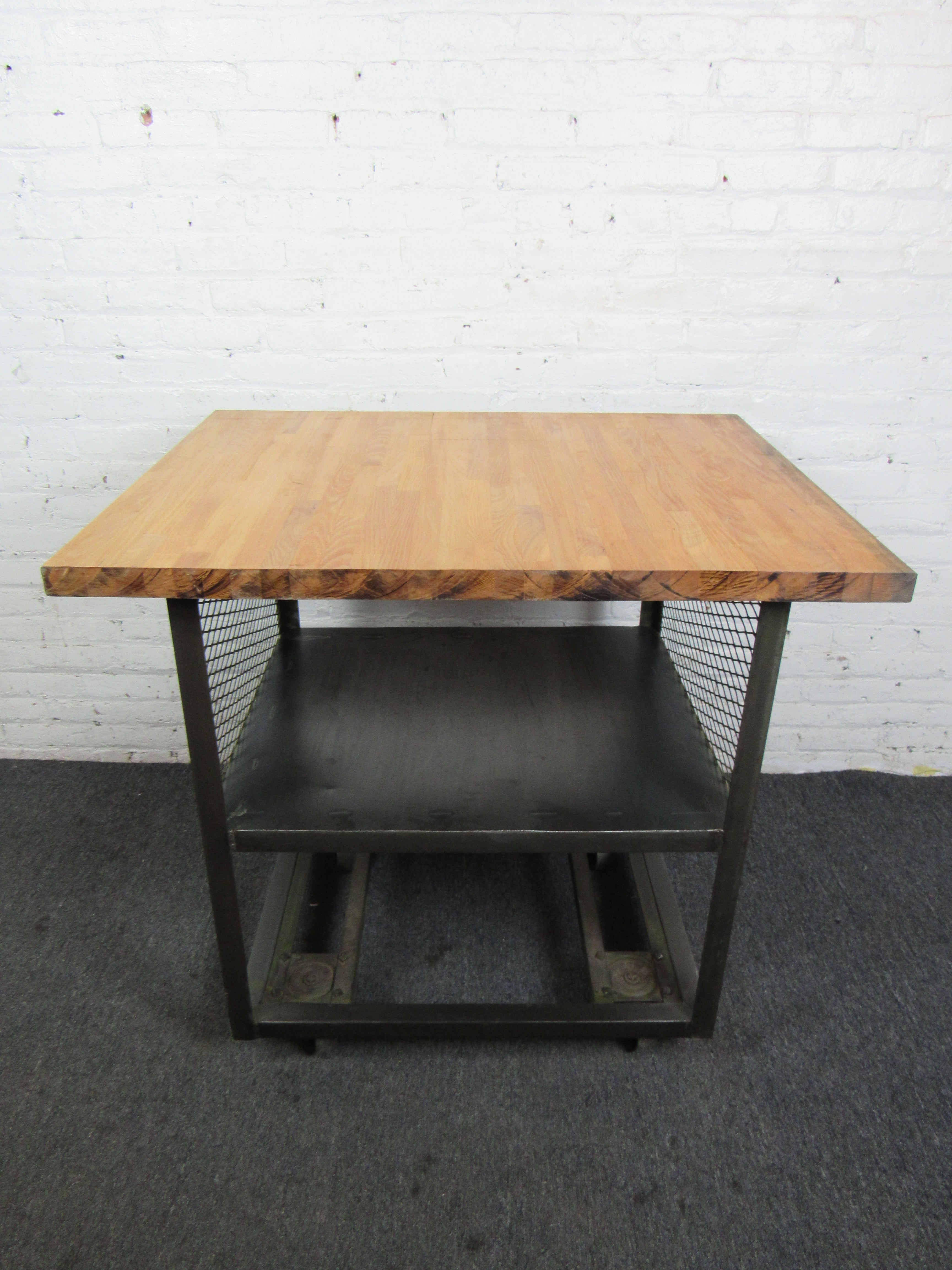 This functional and sturdy industrial style cart features a shelf for storage as well as a butcher block surface. Perfect for a kitchen, workspace, or other uses. Please confirm item location with seller (NY/NJ).
 