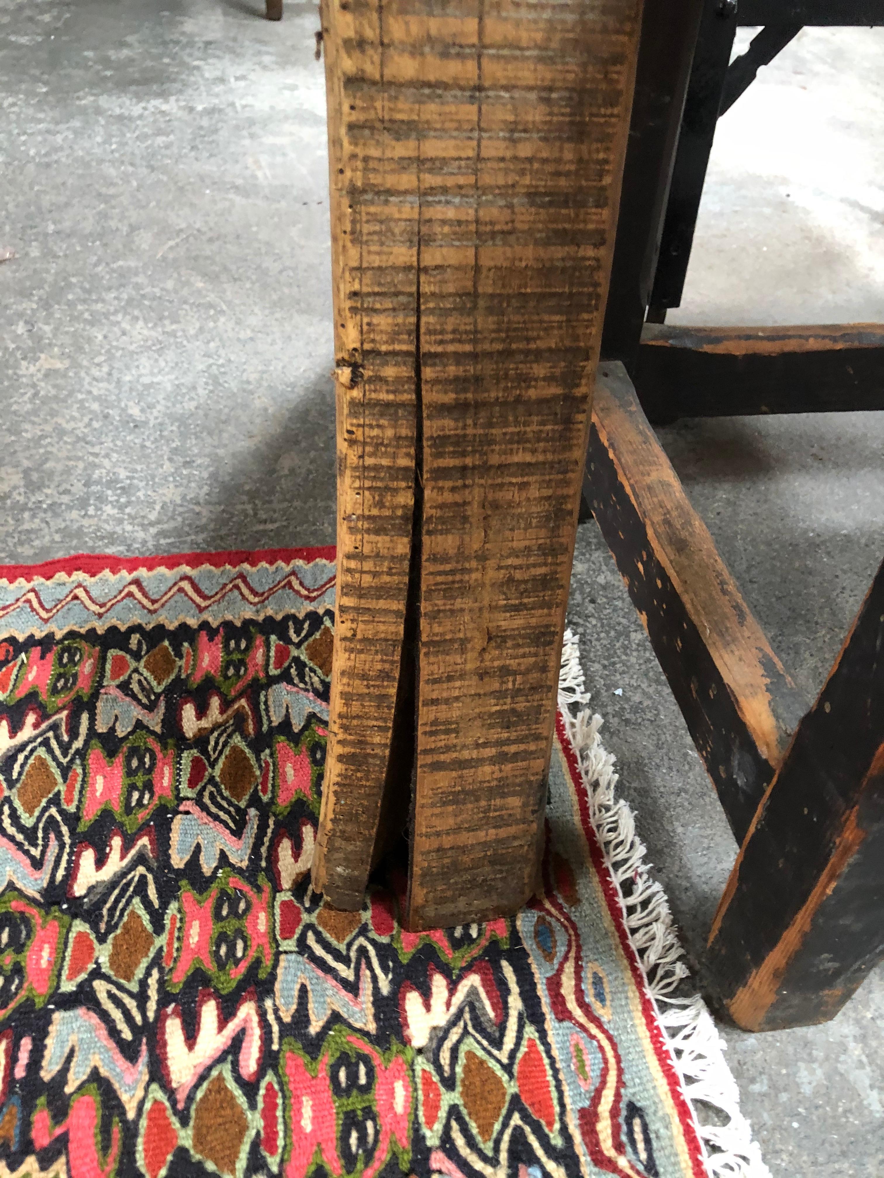 Vintage butcher block console table is an early 1900s piece that sits evenly on all four feet. Thick butcher surface would be great as a chopping block, entryway table, desk, or small bar.