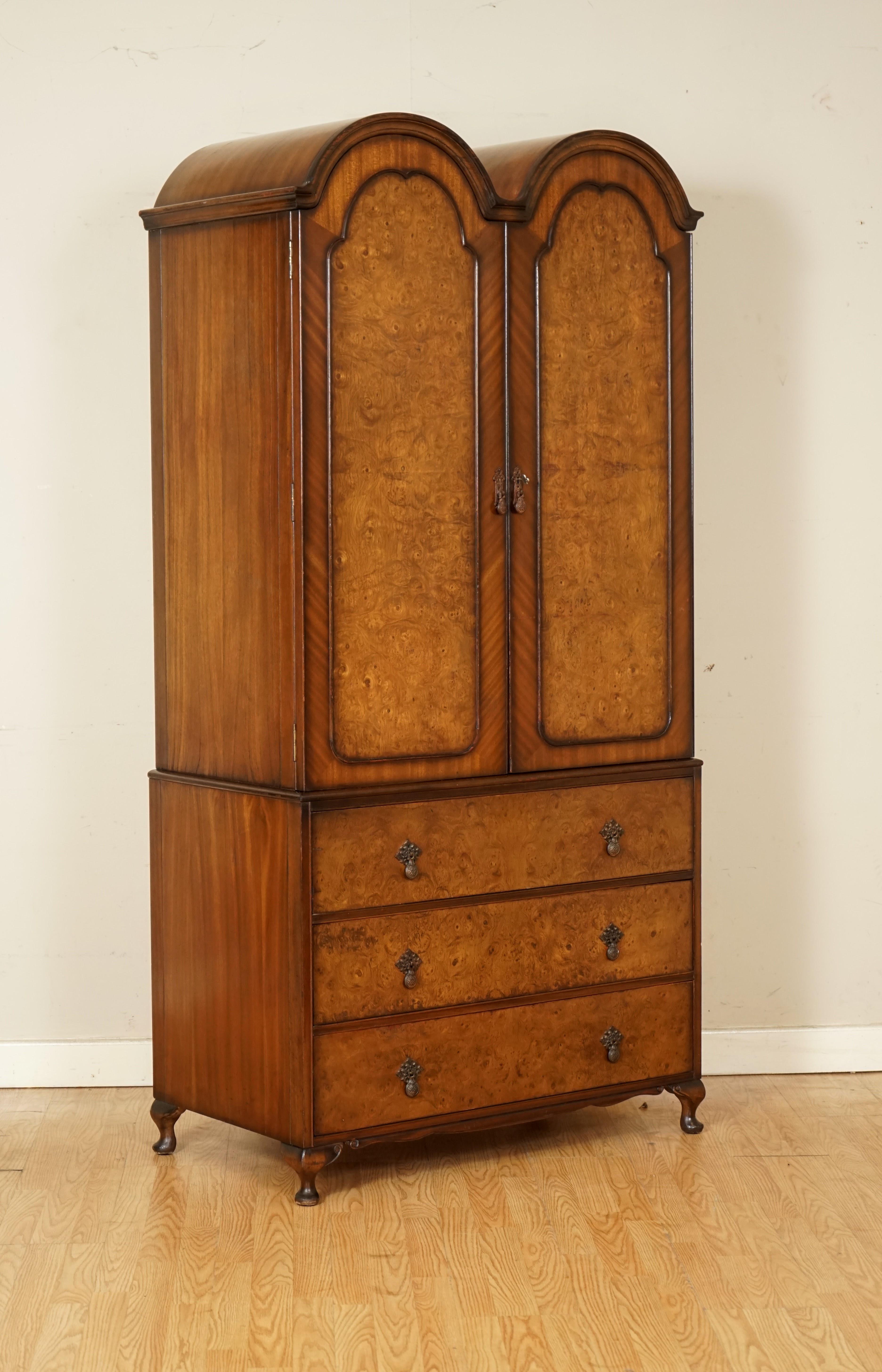We are so excited to present to you this beautiful Burr walnut Art Deco Double wardrobe.

Inside you will find a rail to hang your clothes, a small shelf on the door with a mirror above it and the drawers below.

A solid and very well made