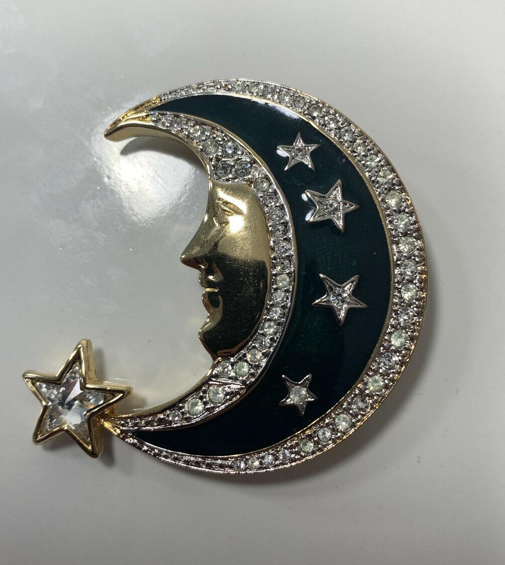 Beautiful Crescent Moon and Stars Brooch set with Sparkling Ice Crystals and enhanced with black Enamel Signed: BUTLER WILSON Brooch. Gold tone mounting. Measures approx. 2”x 2”. Classic and Chic…The perfect accessory for the Modern Woman! 
