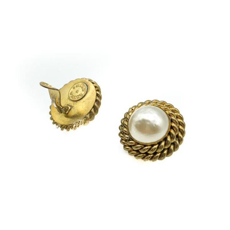 Vintage Butler and Wilson Earrings. Crafted in gold plated brass with a large central glass simulated half maybe pearl. In very good vintage condition, signed, 3.2cms. These are a stunning pair of high quality clip-ons from Butler & Wilson that will