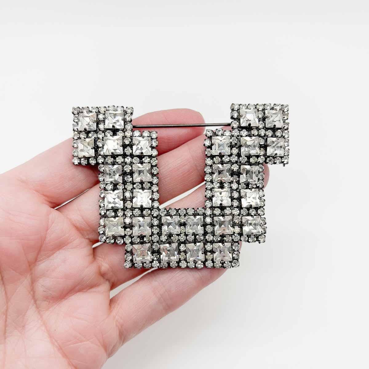 A Vintage Butler & Wilson Deco Brooch. The art deco design and fancy cut crystals proving a glorious combination of glitz and simplicity. A beautiful brooch that will effortlessly transcend the years.
Butler and Wilson began in 1969 selling antique