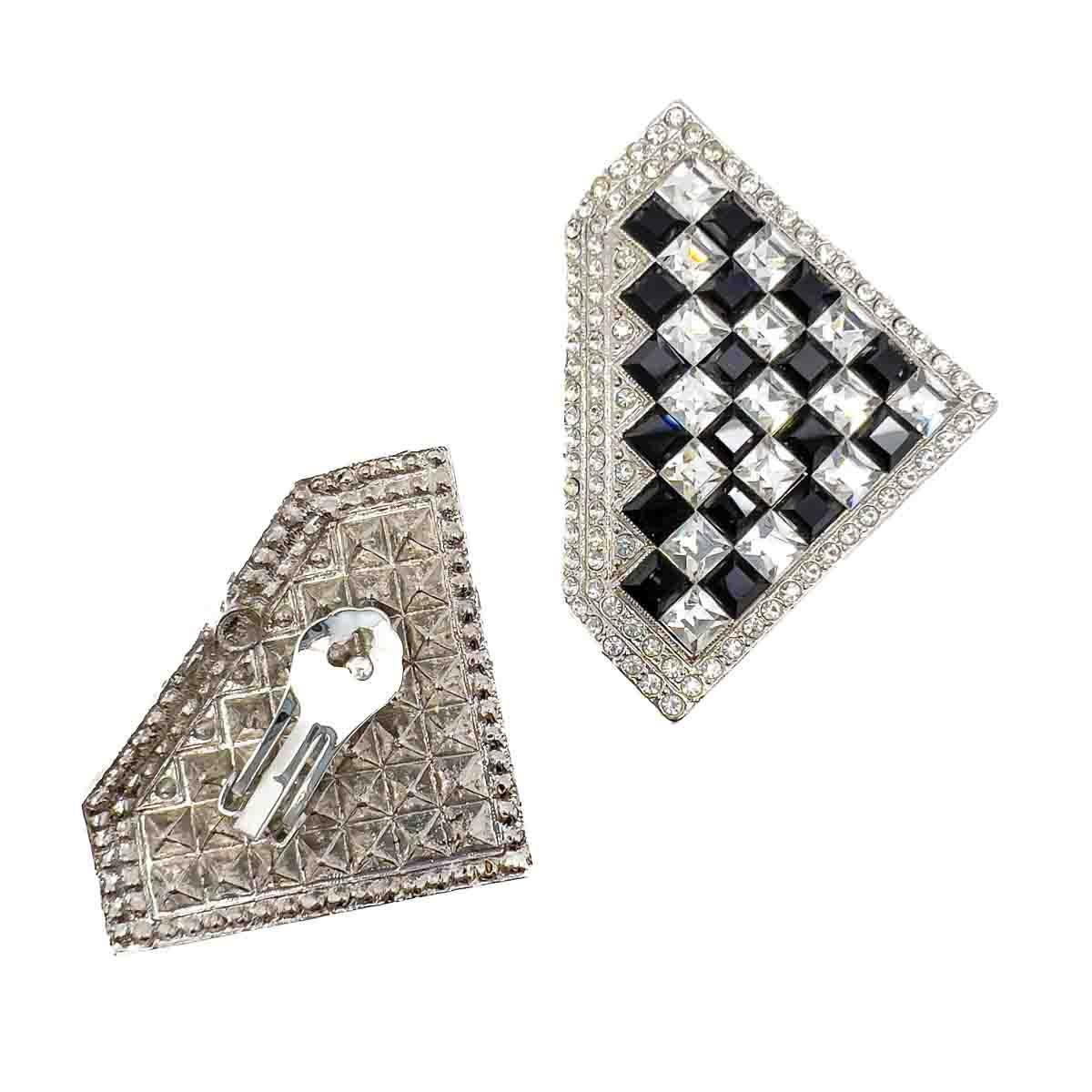 A striking pair of Vintage Butler & Wilson Checkerboard Earrings. Featuring square cut crystals in black and white. A striking style statement that is effortlessly glam.

Butler and Wilson began in 1969 selling antique jewellery in Antiquarius on