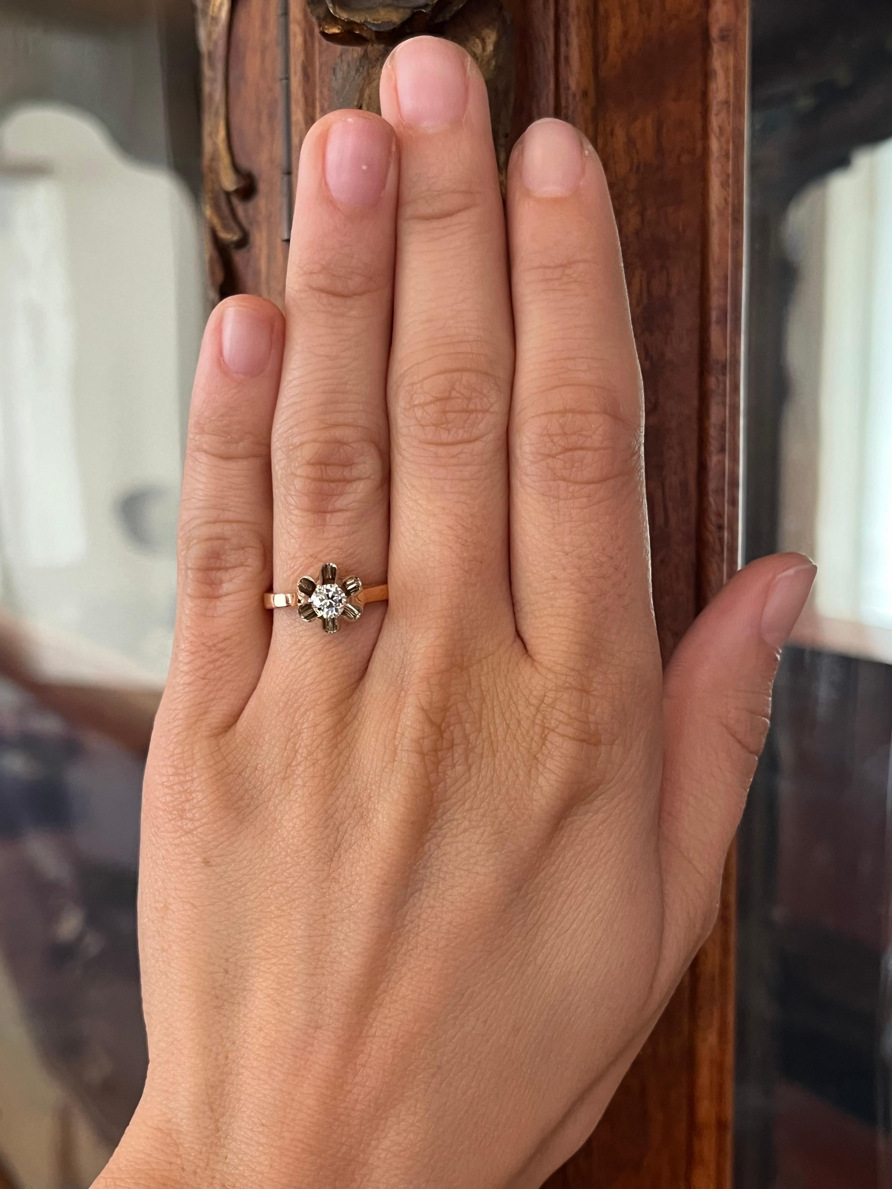 A soft blend of metals frames the charm of a 0.27ct old European cut diamond in this antique Buttercup solitaire. Set with a white gold head atop a 14K rose gold shank, this Russian-made piece radiates history and romance. From our estate fine
