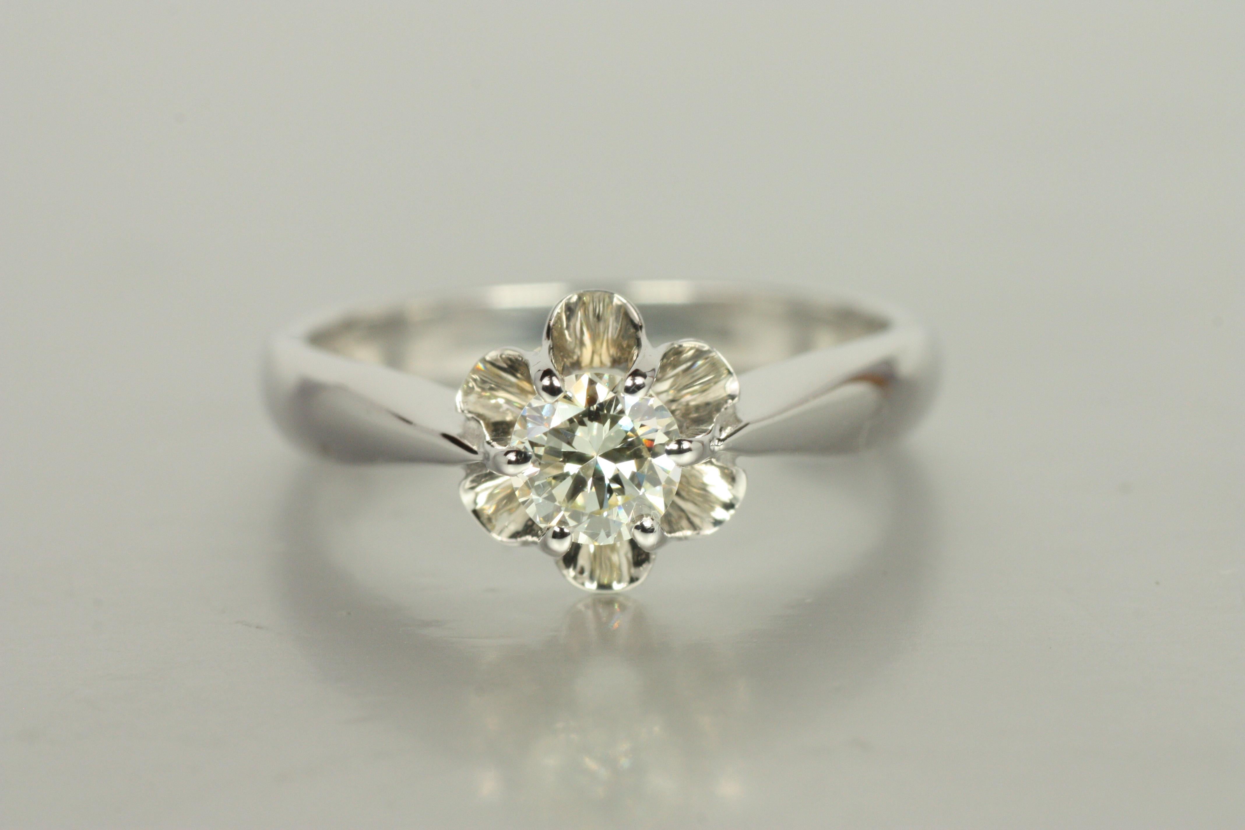 A classic Buttercup solitaire setting in luminous 14K white gold cradles a 0.31ct round brilliant cut diamond. With VS1 clarity and a warm K color, this vintage treasure evokes understated elegance. From our estate collection, this piece offers