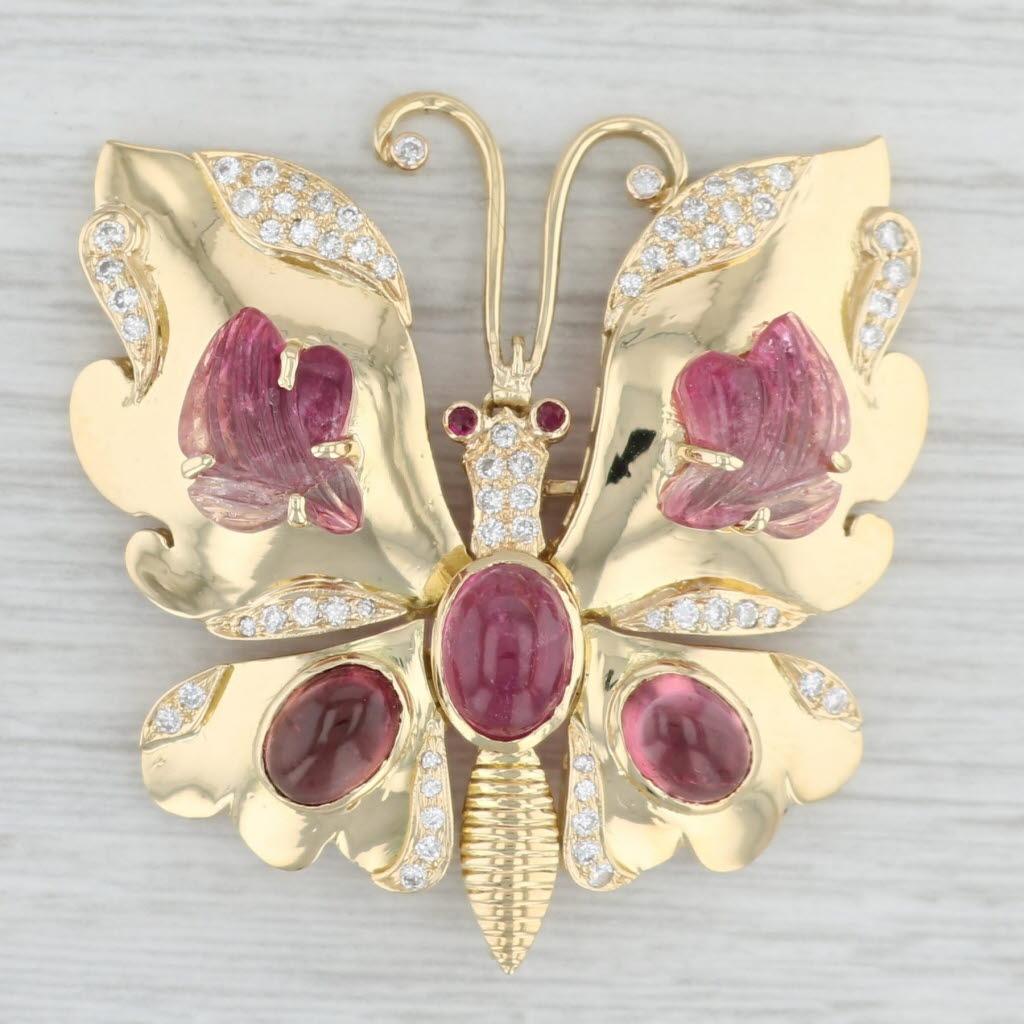 This beautiful statement brooch has a butterfly design with wings that articulate.

Gemstone Information:
- Natural Diamonds -
Total Carats - 0.42ctw 
Cut - Round Brilliant
Color - G - I
Clarity - SI1 - I1

- Natural Tourmaline -
Size - 5 x 7 mm & 6