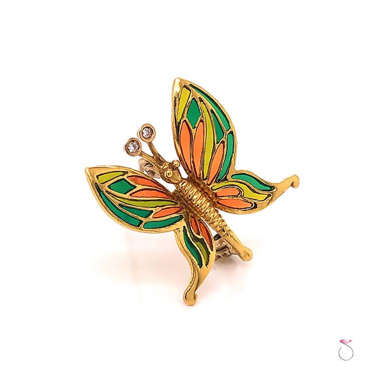 Beautiful vintage butterfly enamel & diamond brooch in 18K yellow gold. This brooch features pretty details and workmanship. The brooch has stunning glass enamel in vibrant colors on the butterfly wings. Two round diamonds are set at the end of the