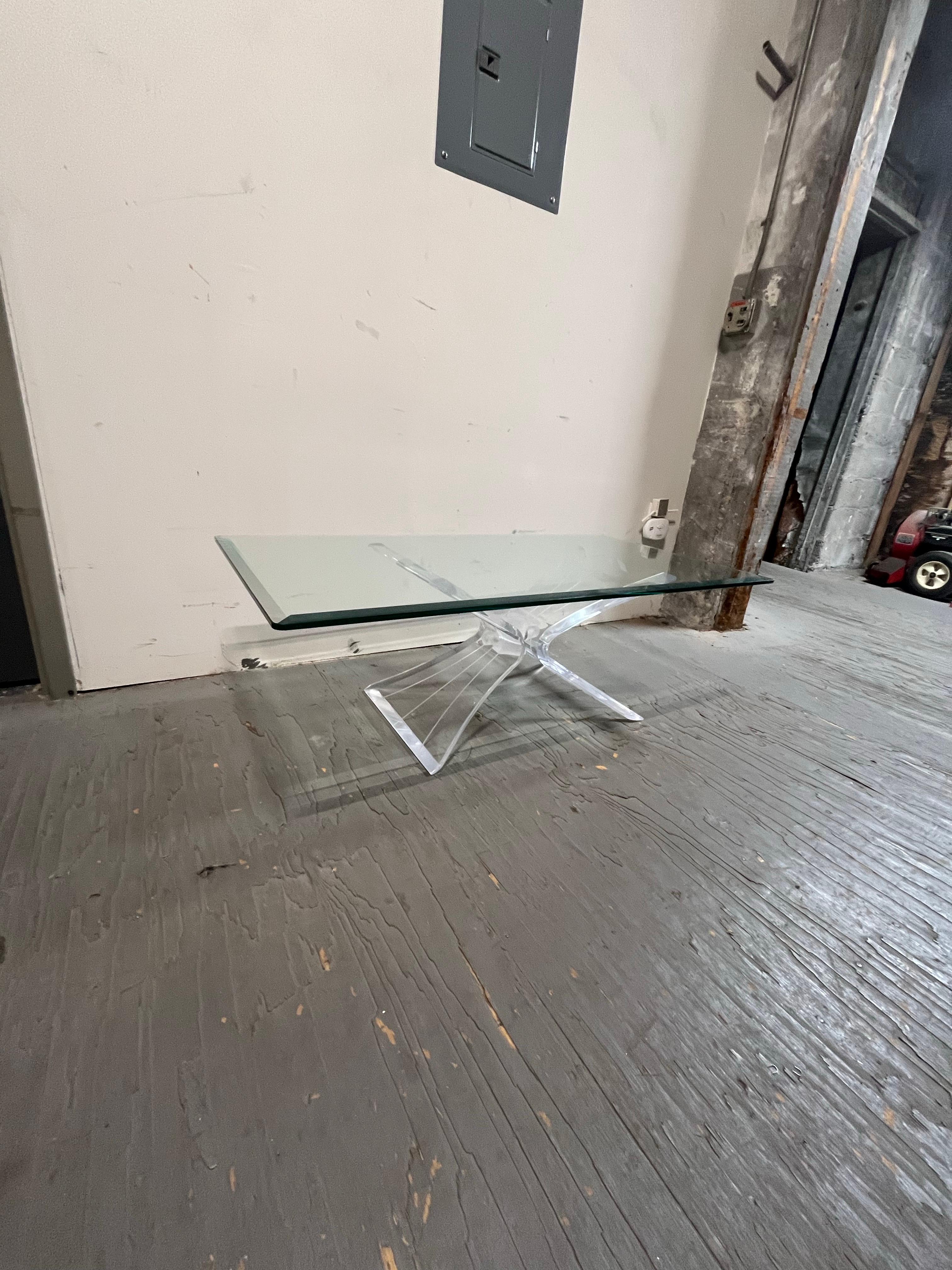 Mid-Century Modern Lucite and glass coffee table signed in the manner of Lion in Frost and Astrolite. This piece features a sculptural acrylic butterfly base frosted lucite center piece. Nice beveled edge glass top adds more transparency designed to