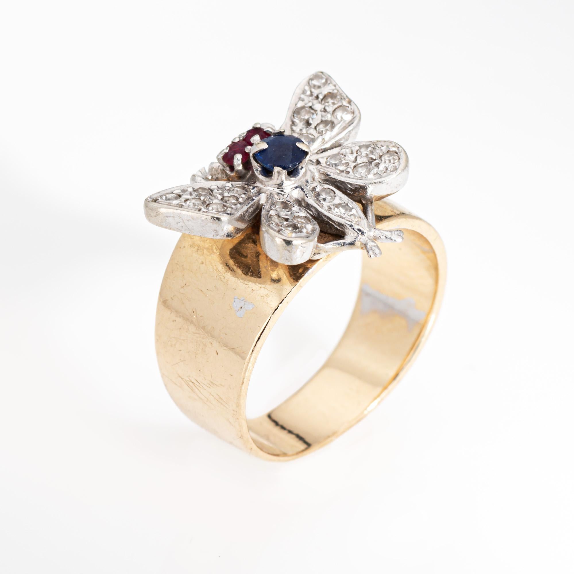 Stylish vintage butterfly ring (circa 1960s to 1970s) crafted in 14 karat yellow & white gold. 

Two approx. 1.5mm rubies and one approx. 3.5mm sapphire are set into the mount. 22 single cut diamonds total an estimated 0.10 carat (estimated at I-J