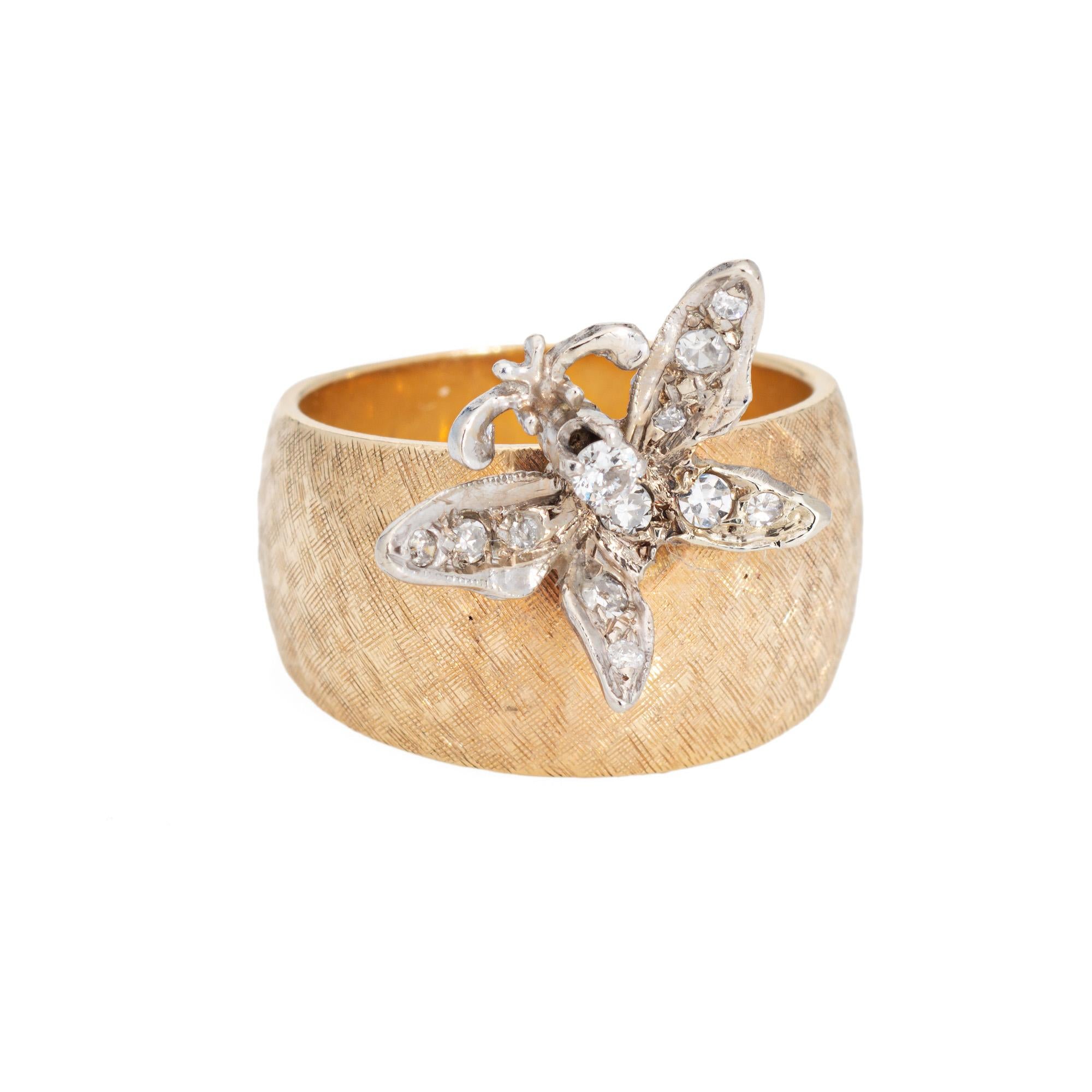 Stylish vintage butterfly ring (circa 1960s to 1970s) crafted in 14 karat yellow & white gold. 

12 diamonds total an estimated 0.10 carat (estimated at I-J color and SI1-I2 clarity). 

The sweet ring highlights a diamond set butterfly. Perched in a