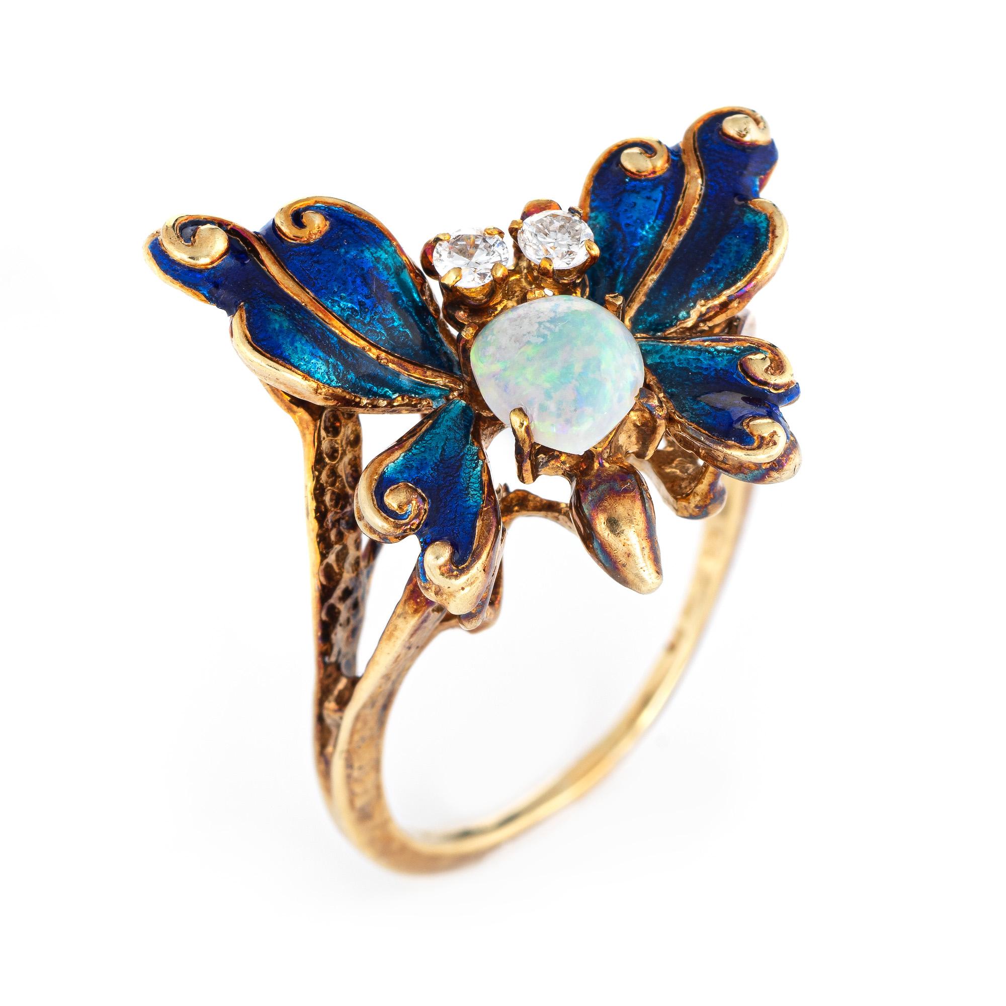 Stylish vintage butterfly cocktail ring (circa 1950s to 1960s) crafted in 14 karat yellow gold. 

Opal measures 6.5mm (estimated at 1 carat), accented with two estimated 0.05 carat diamonds. The total diamond weight is estimated at 0.10 carats