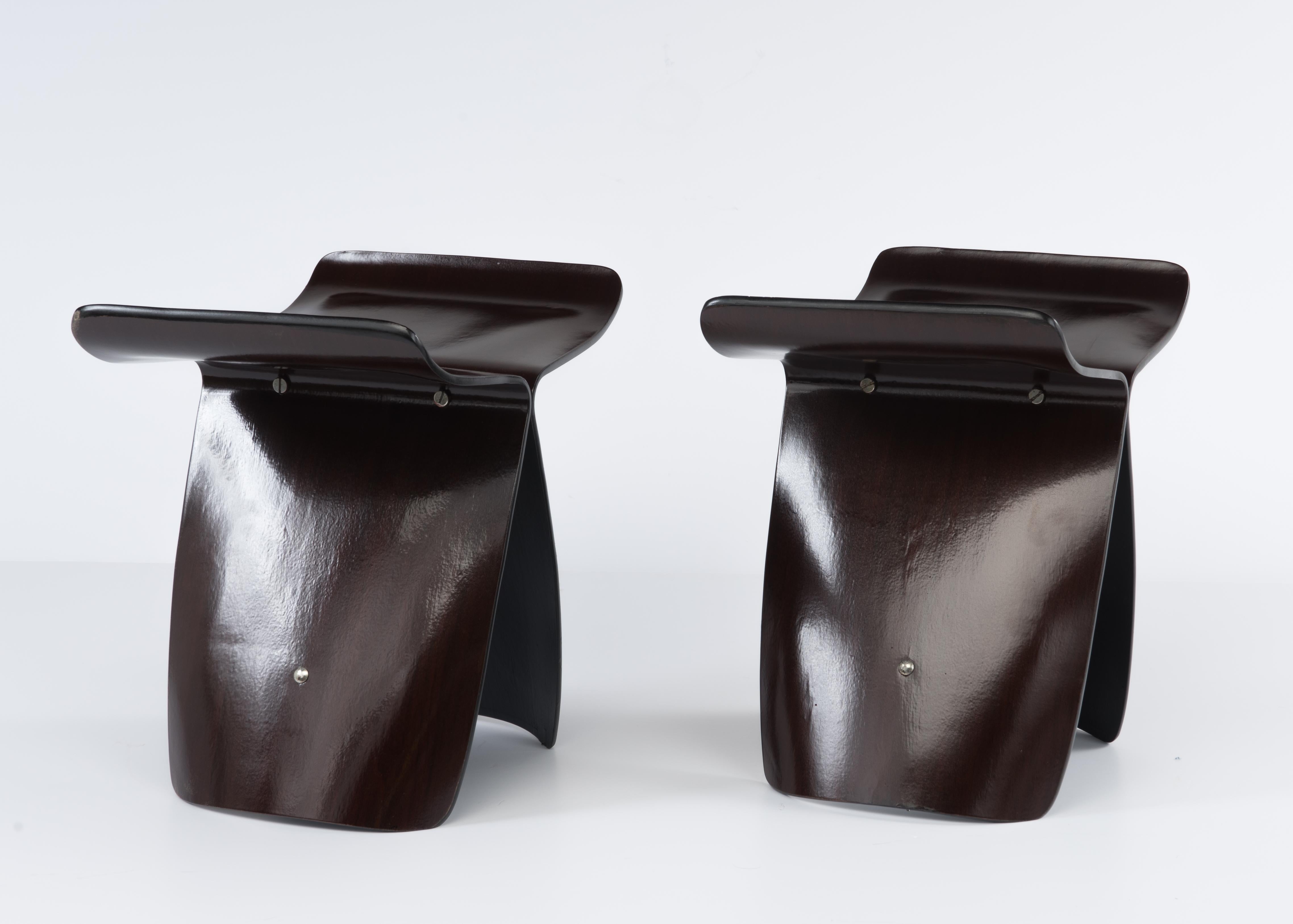 A pair of vintage molded plywood butterfly stool designed by Sori Yanagi for Tendo Mokko. Dark brown finish on a Japanese paper veneer with stainless steel hardware. Black painted edges and underside. Measures: 17