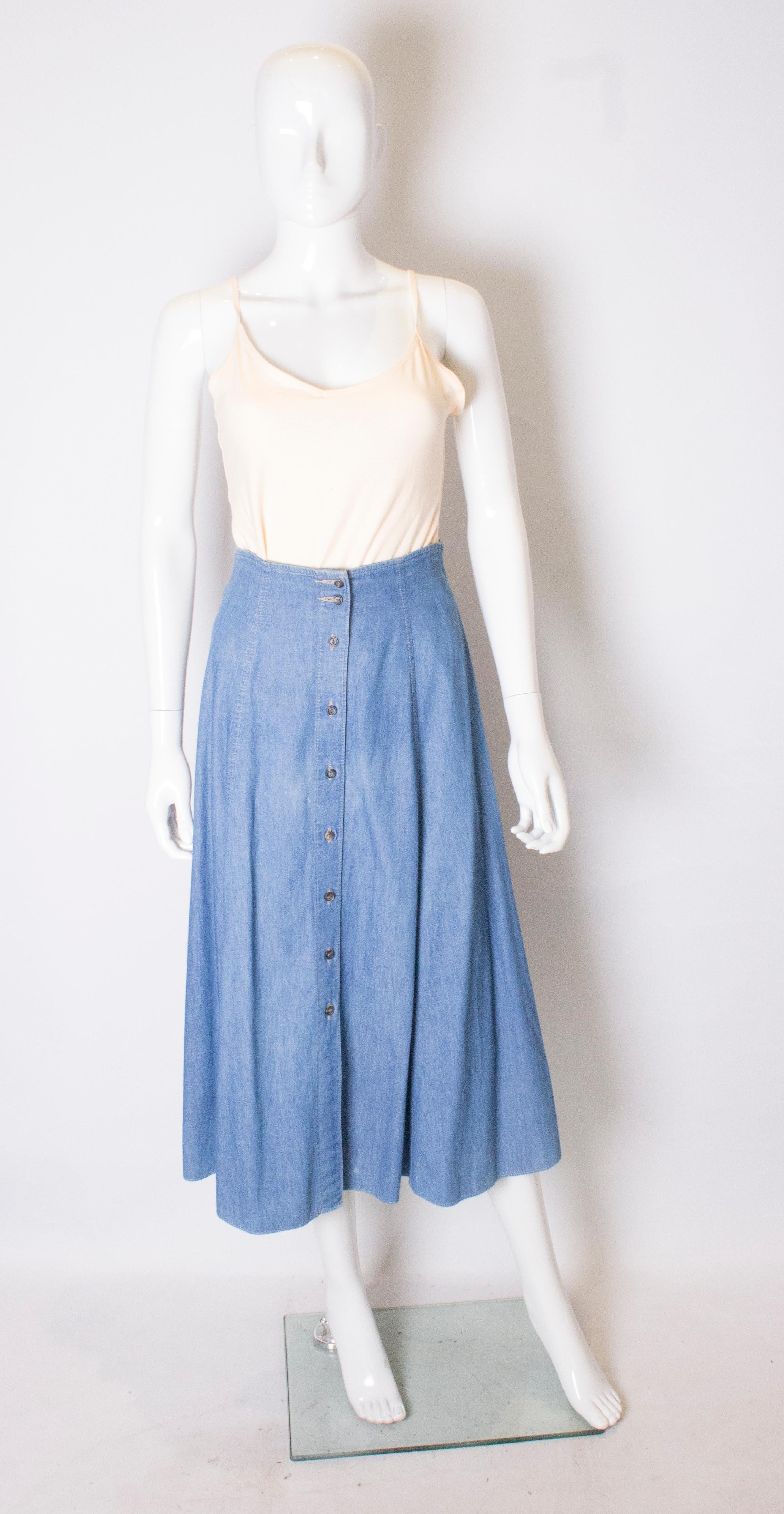 An easy to wear vintage denim skirt by Marks and Spencers /St Michaels. The skirt is in a soft blue colour with button through opening , and is panelled.