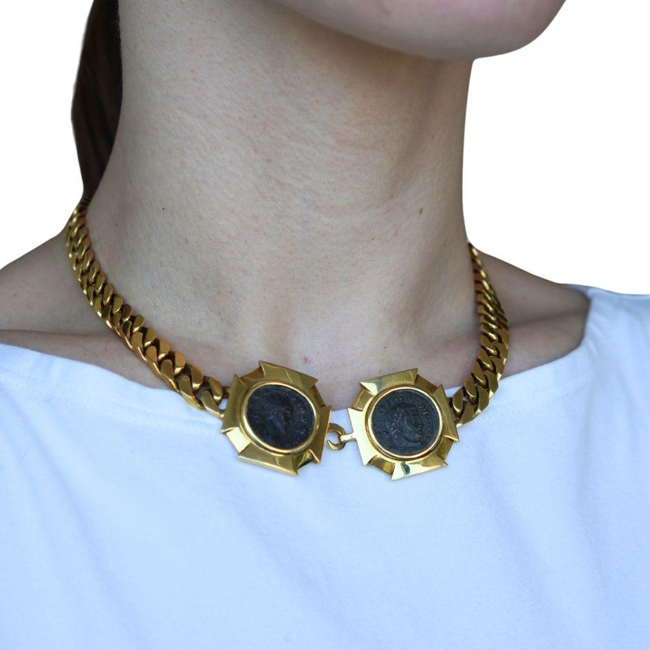 This circa 1980s Bvlgari 18k gold Monete necklace features a rare double ancient Roman coin design. Crafted in solid 18k yellow gold, the necklace measures 16.5 inches in length and weighs 118.4 grams. At the center are two bezel-set bronze coins,