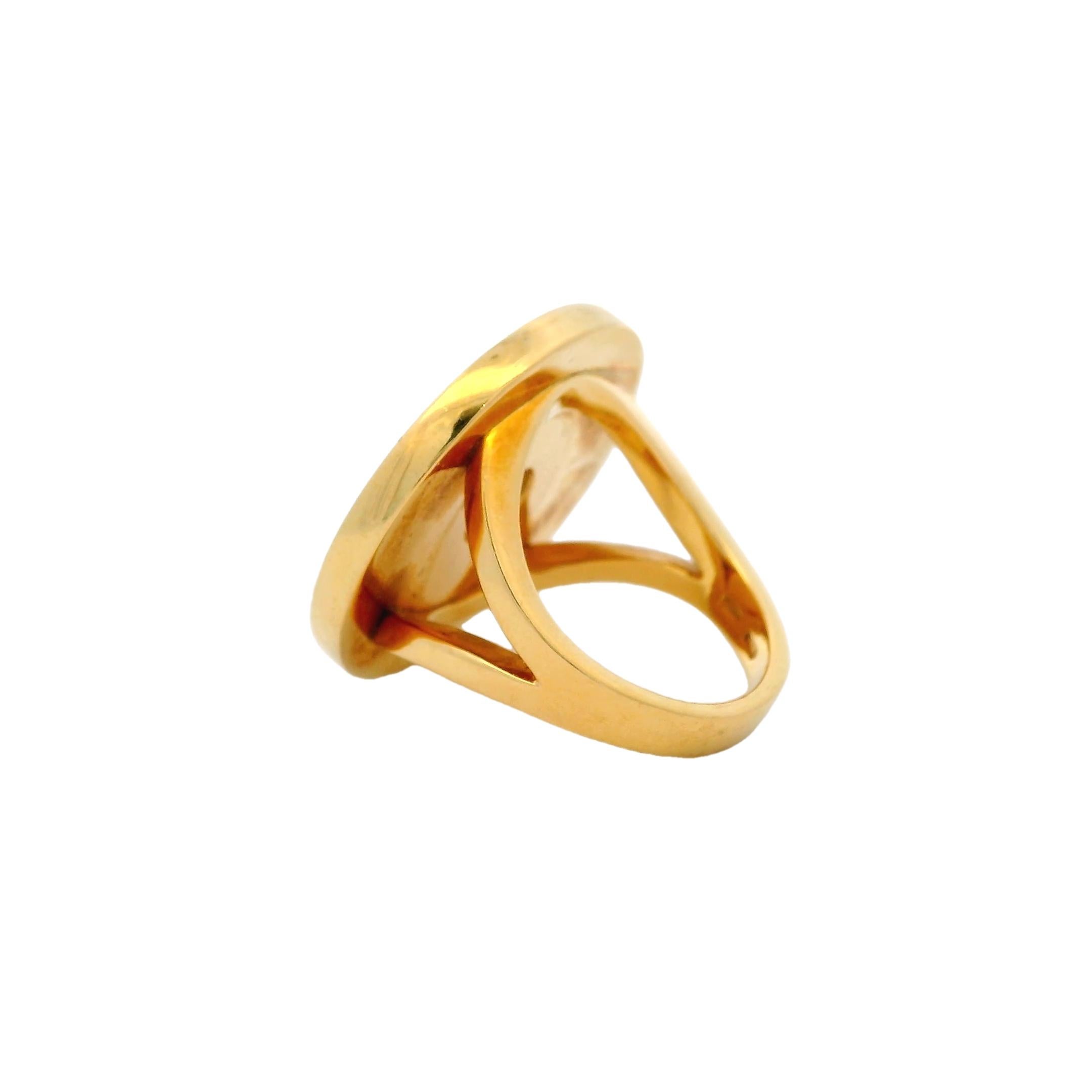 Icône intemporelle de la collection BVLGARI BVLGARI, cette bague exquise présente un centre en nacre lumineuse encadré par le double logo signature de la marque en or jaune 18 carats. Inspiré des anciennes pièces de monnaie romaines, le design
