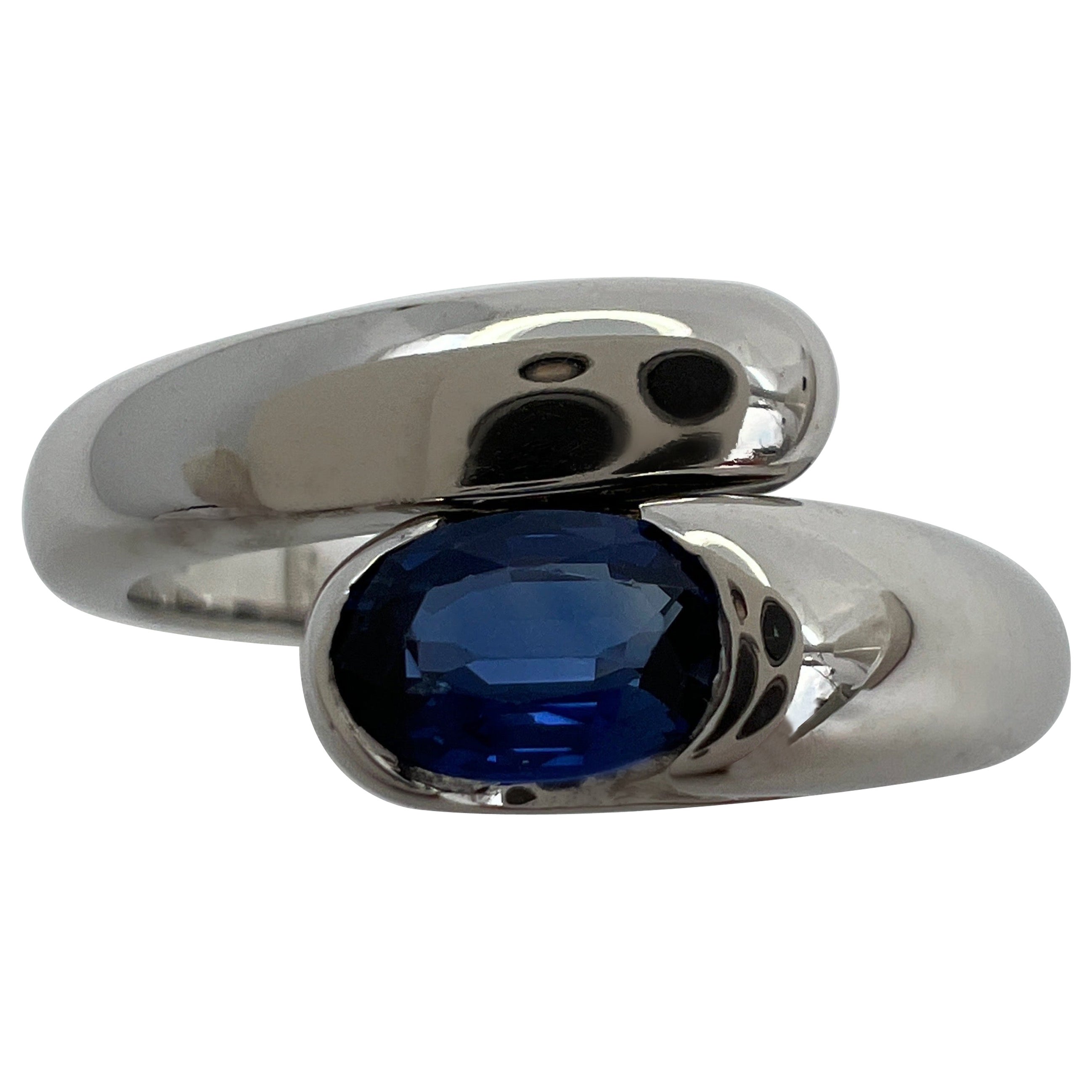 Vintage Bvlgari Astrea Vivid Blue Sapphire Oval Cut 18k White Gold Bypass Ring For Sale