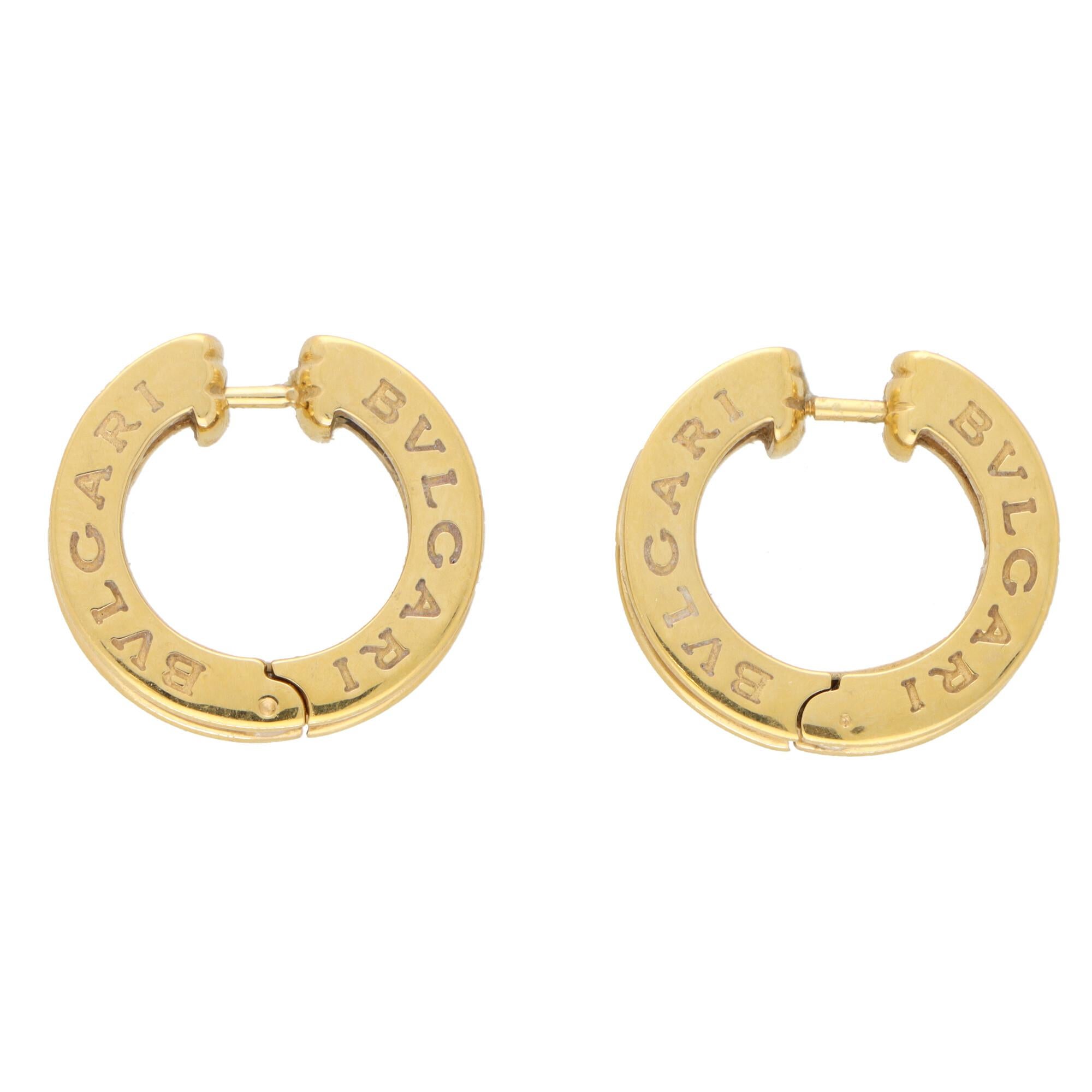 A stylish pair of vintage Bvlgari B.zero1 diamond hoop earrings set in 18k yellow gold. 

The earrings are designed in the iconic Bvlgari B.zero1 motif, and are set half way with round brilliant cut diamonds. The hoops are secured with a post and