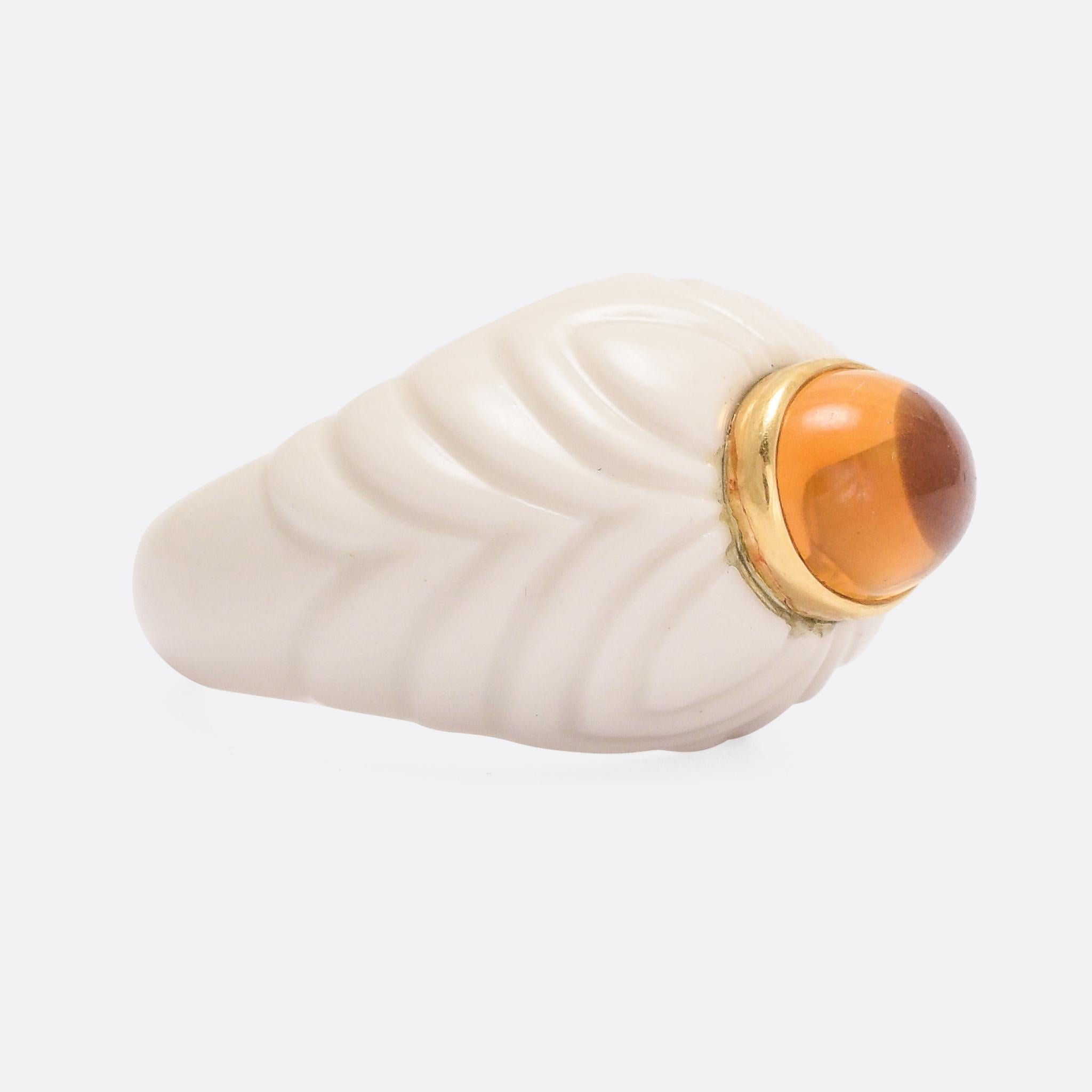 A striking vintage Bulgari Chandra ring fashioned in porcelain and set with a vibrant citrine cabochon. The white porcelain has been carved with a flower-like design, and the stone rests in an 18k gold bezel setting. Fully marked Bulgari 750 with