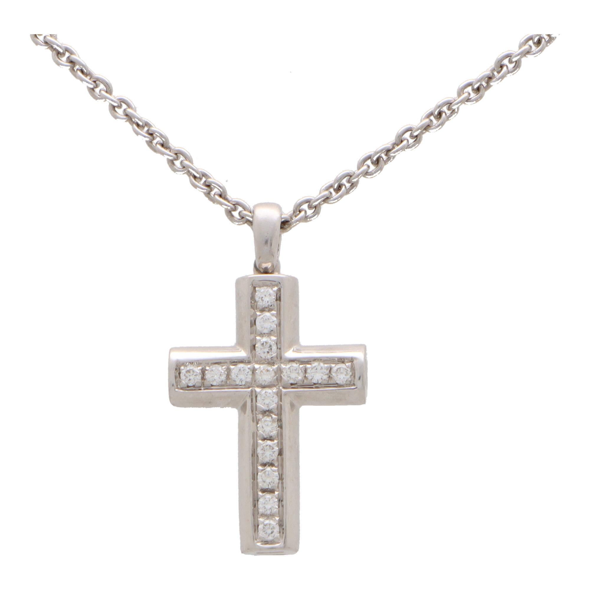 A stylish vintage Bvlgari Latin cross necklace set in 18k white gold.

The pendant depicts a cross motif and is pave set with exactly 16 round brilliant cut diamonds. The cross hangs from a polished white gold bail set bail. Accompanied with the