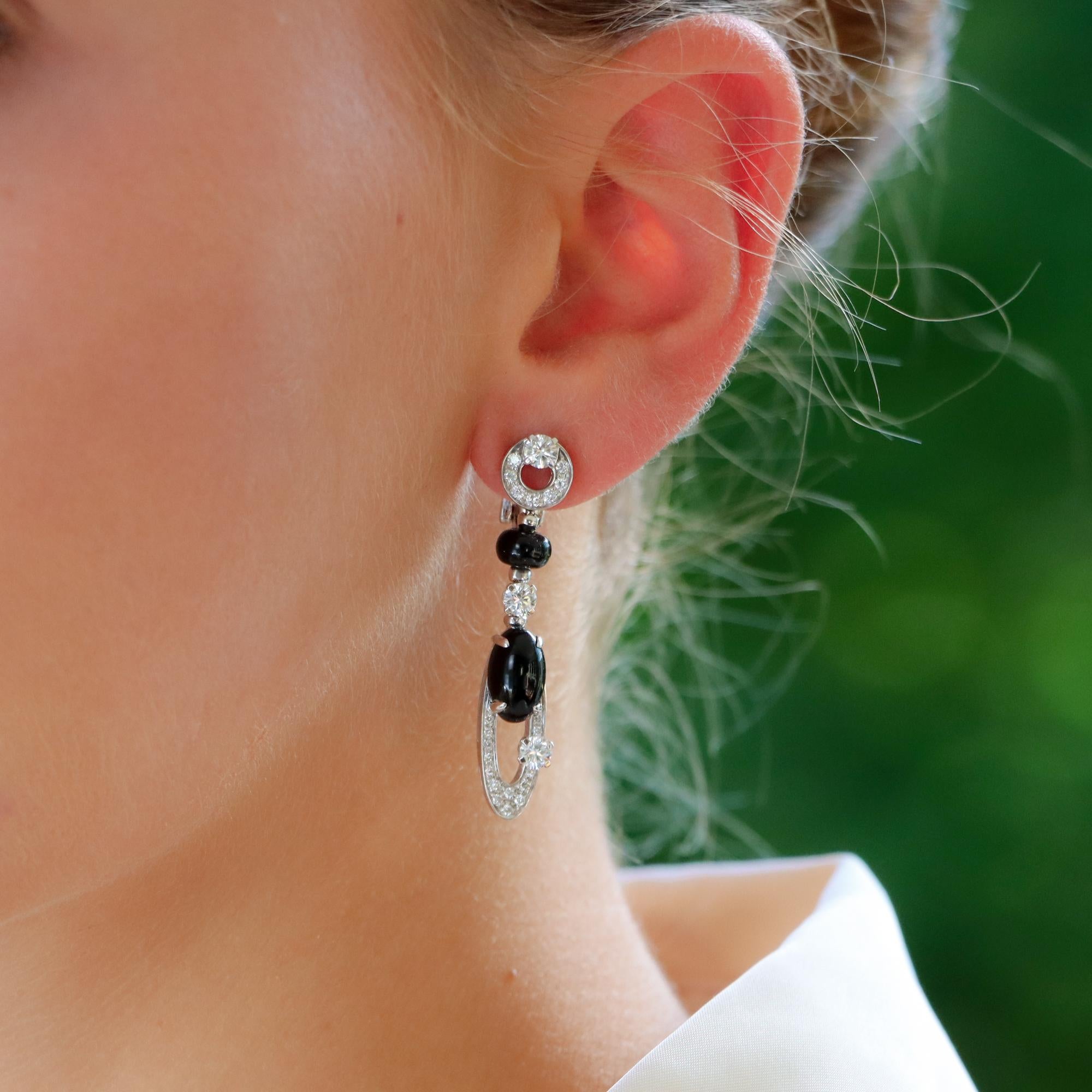 A rather unique pair of vintage Bvlgari ‘Elisia’ diamond and onyx earrings set in 18k white gold.

From the now discontinued ‘Elisia’ collection, each earring is firstly composed of a diamond ring, set to the stop with a larger claw set round
