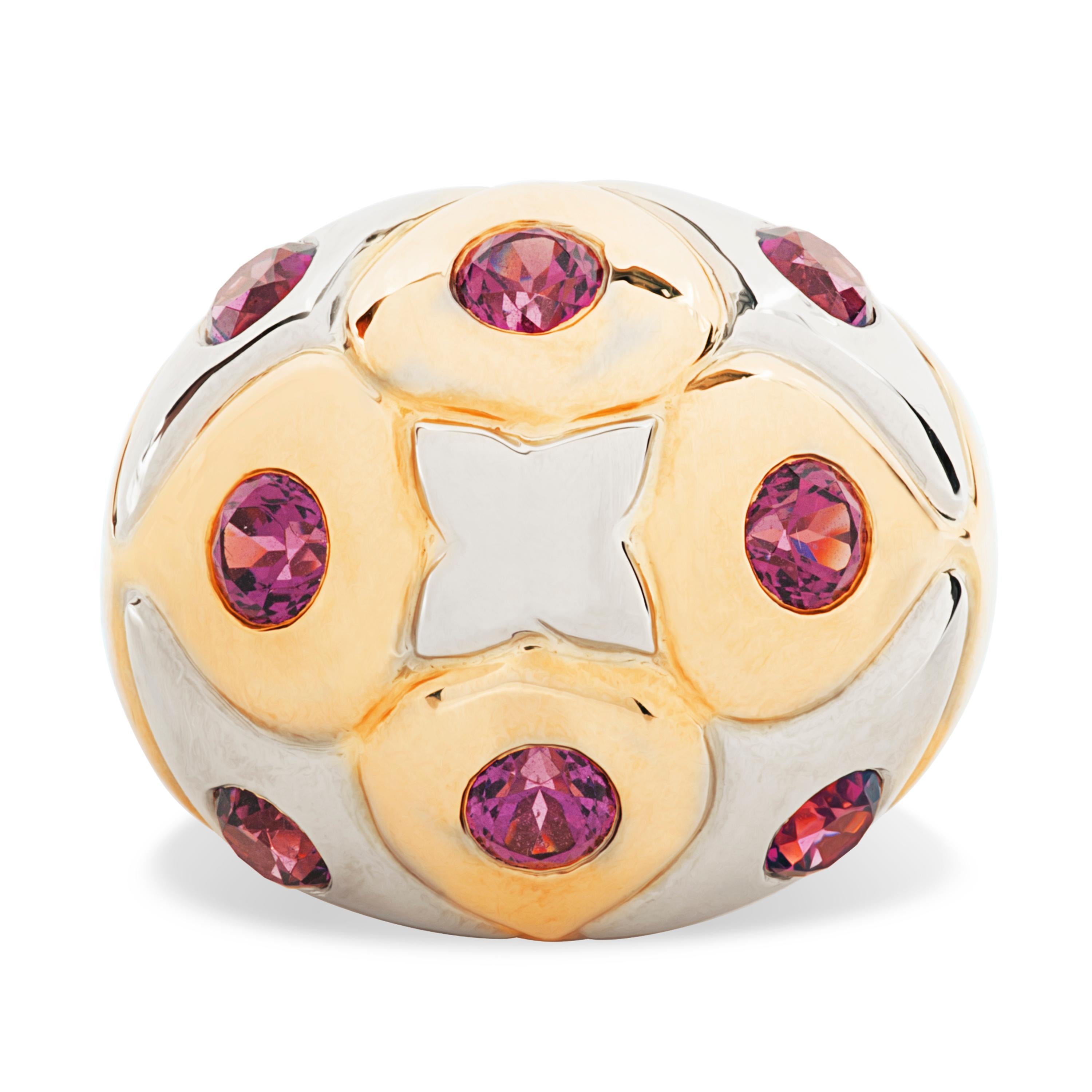This vintage Bvlgari ring features 8 round garnets totaling approximately 2.60 carats set in a raised two toned 18k yellow and white gold dome.

The dome measures 20mm wide and tapers down to 3.3mm at the bottom of the shank.  The top of the dome