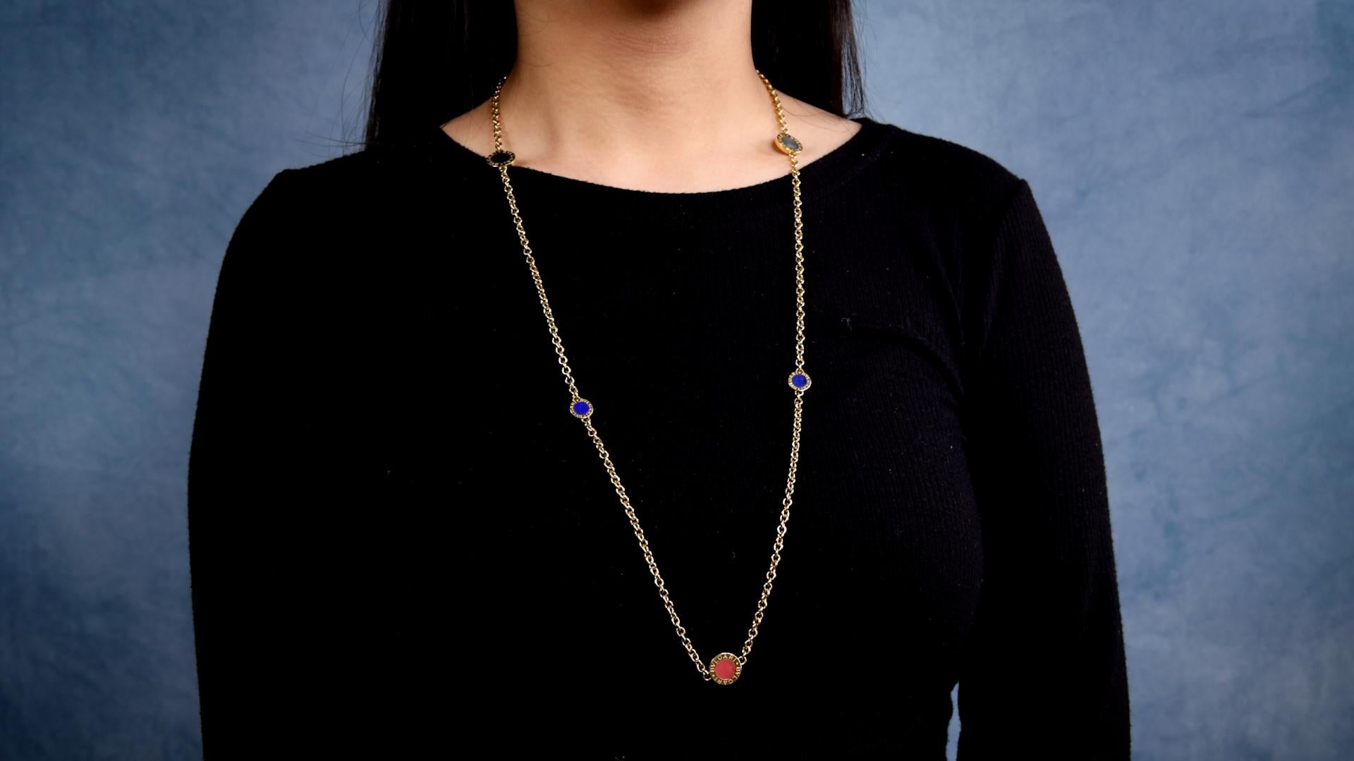 One Vintage Bvlgari Gemstone 18k Yellow Gold Disc Necklace. Featuring lapis lazuli, onyx, coral, and agate. Crafted in 18 karat yellow gold signed Bvlgari with Italian hallmarks, weighing 39.83 grams. Circa 2000. The necklace is 31 inches in